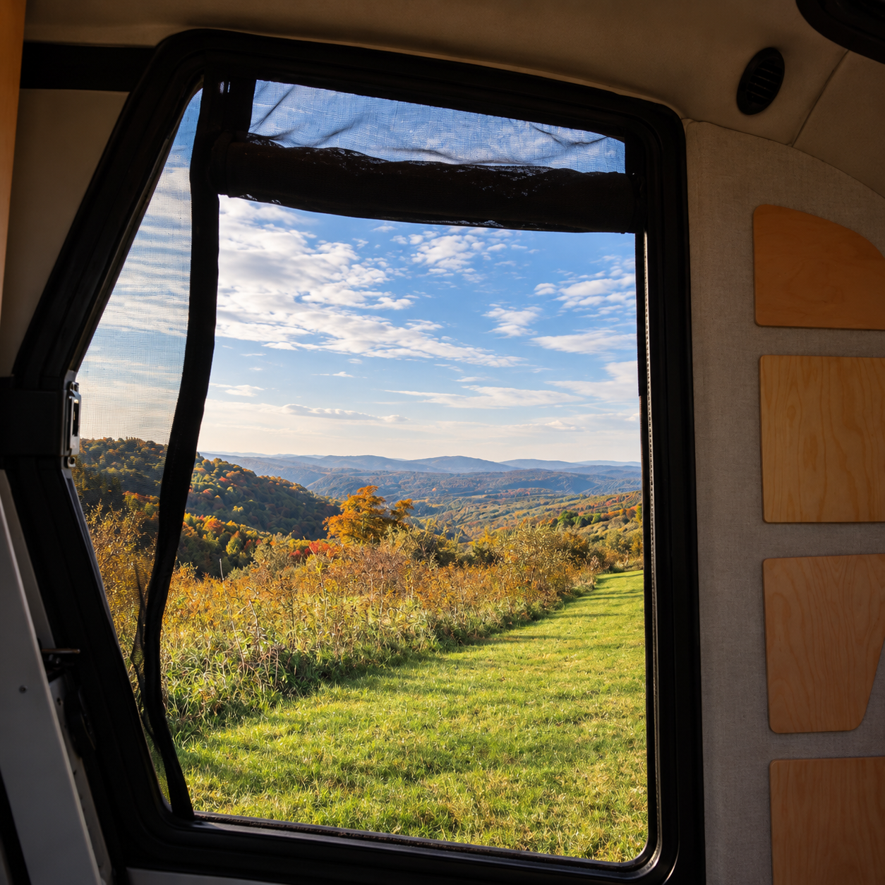 Escapod Topo 2 teardrop trailer window reflecting autumn mountains beside a Toyota Tundra at Spruce Knob Mountain Center, West Virginia