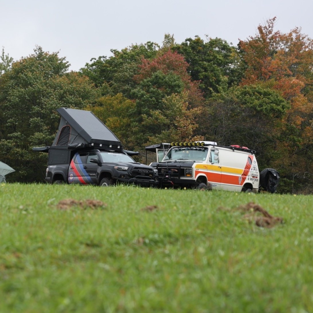 Overland rigs with a rooftop camper and a 4x4 van parked in the meadow camp at Canaan Valley, West Virginia