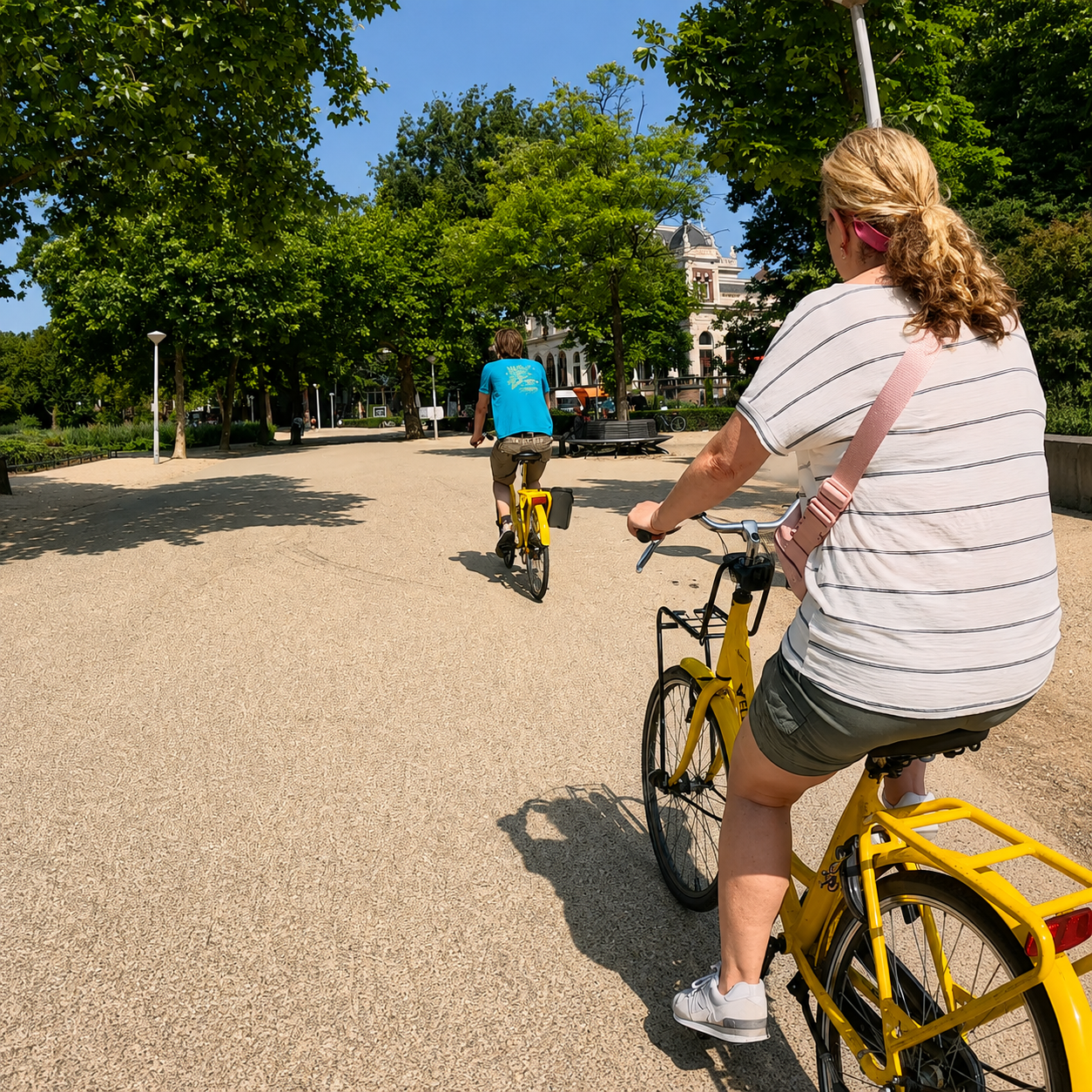 Yellow rental bikes on a path in Vondelpark, Amsterdam