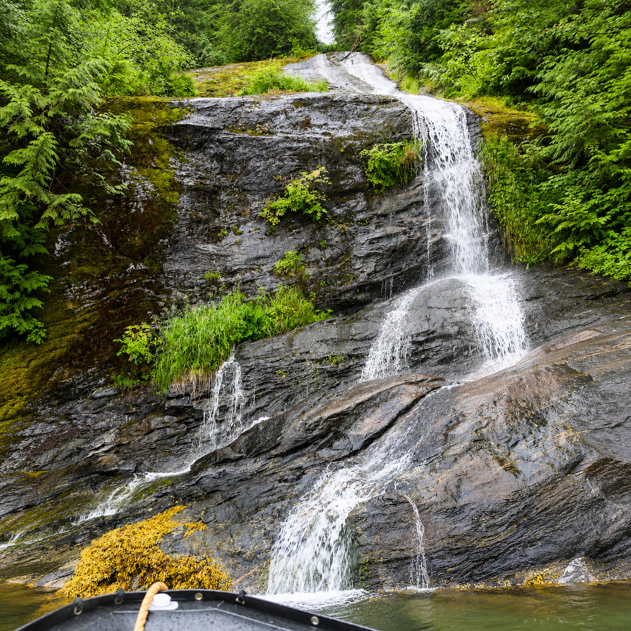 Waterfall cascading down granite cliffs in Misty Fjords National Monument Alaska