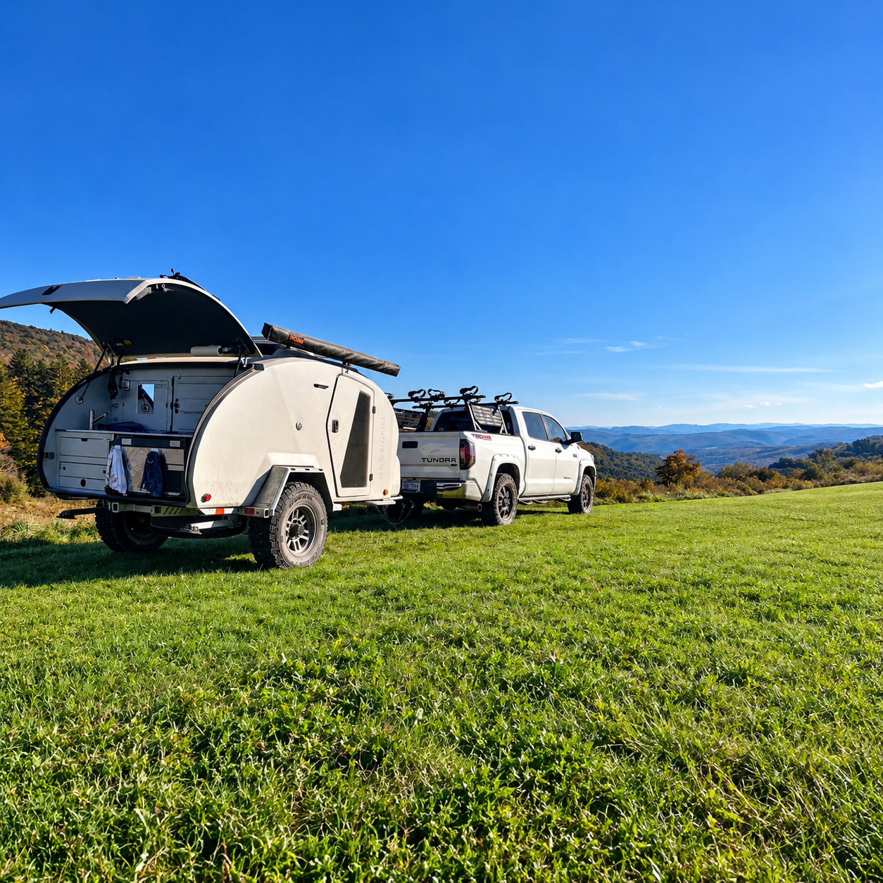 Overland rigs camped on a hilltop above the mountain valley at Spruce Knob Mountain Center, West Virginia