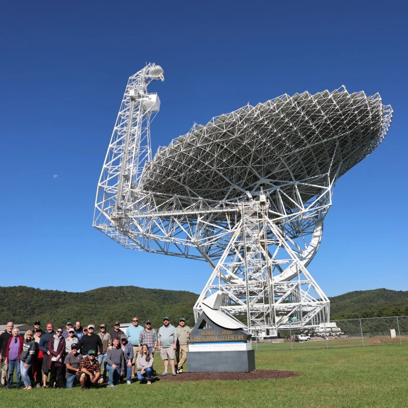 The Overlander Project expedition group posing beneath the Robert C. Byrd Green Bank Telescope in West Virginia