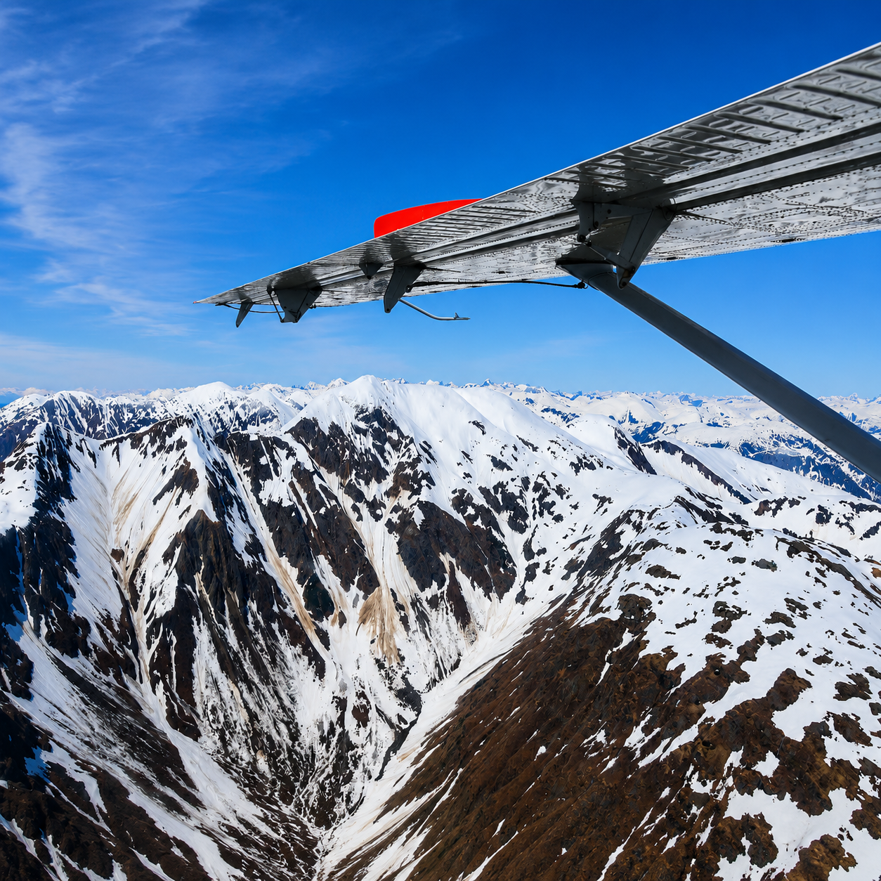 View from a Wings Airways seaplane over a snow-covered mountain range on the flight to Taku Lodge near Juneau, Alaska