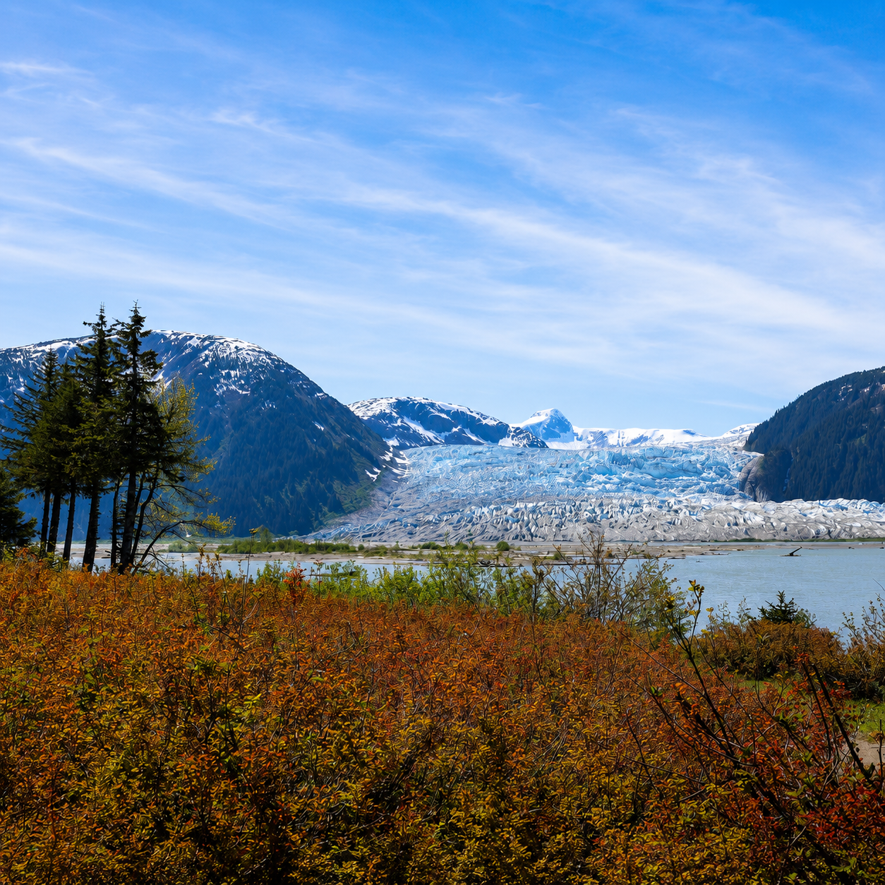 Glacier and mountain landscape viewed across the river from the grounds of Taku Glacier Lodge, Alaska