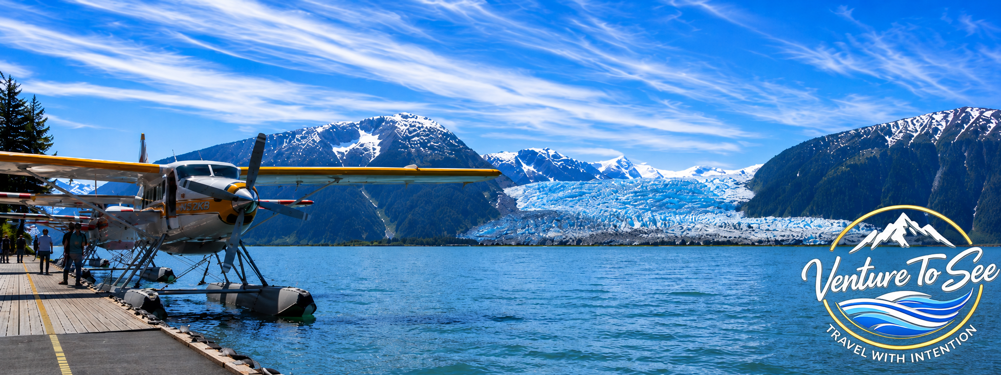 Panoramic view of a Wings Airways seaplane on the Taku River with the Taku Glacier and mountains behind at Taku Glacier Lodge, Alaska
