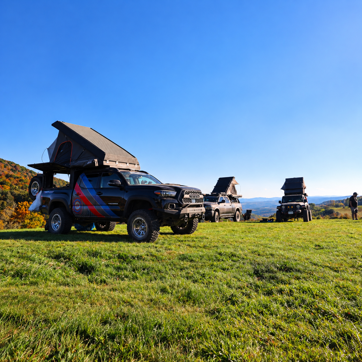 Overland campsite with an Escapod Topo 2 teardrop trailer and Toyota Tundra above rolling West Virginia hills at Spruce Knob Mountain Center
