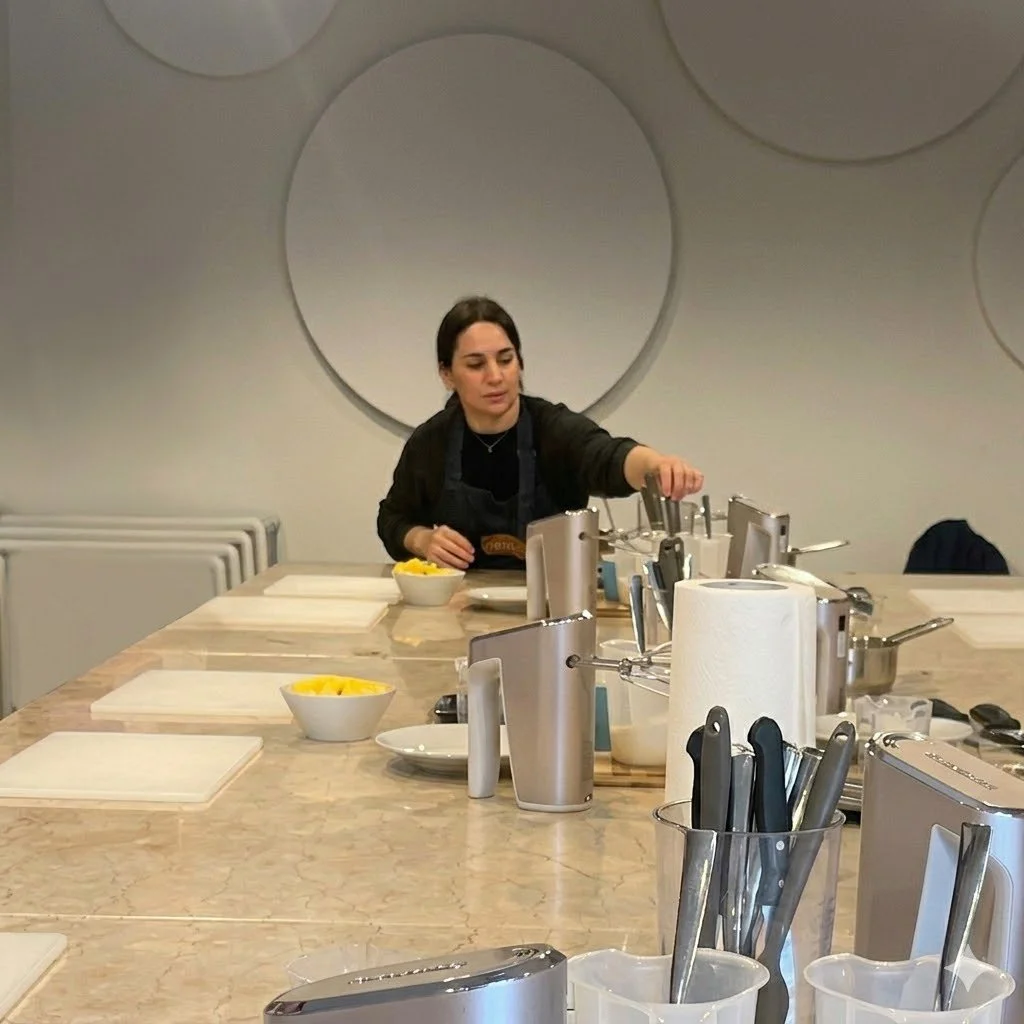 Gelato class instructor in Verona setting up marble prep tables before the class