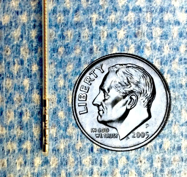 DBS lead. The DBS lead is thin, only 1.3 mm in diameter, shown here to scale with a dime.