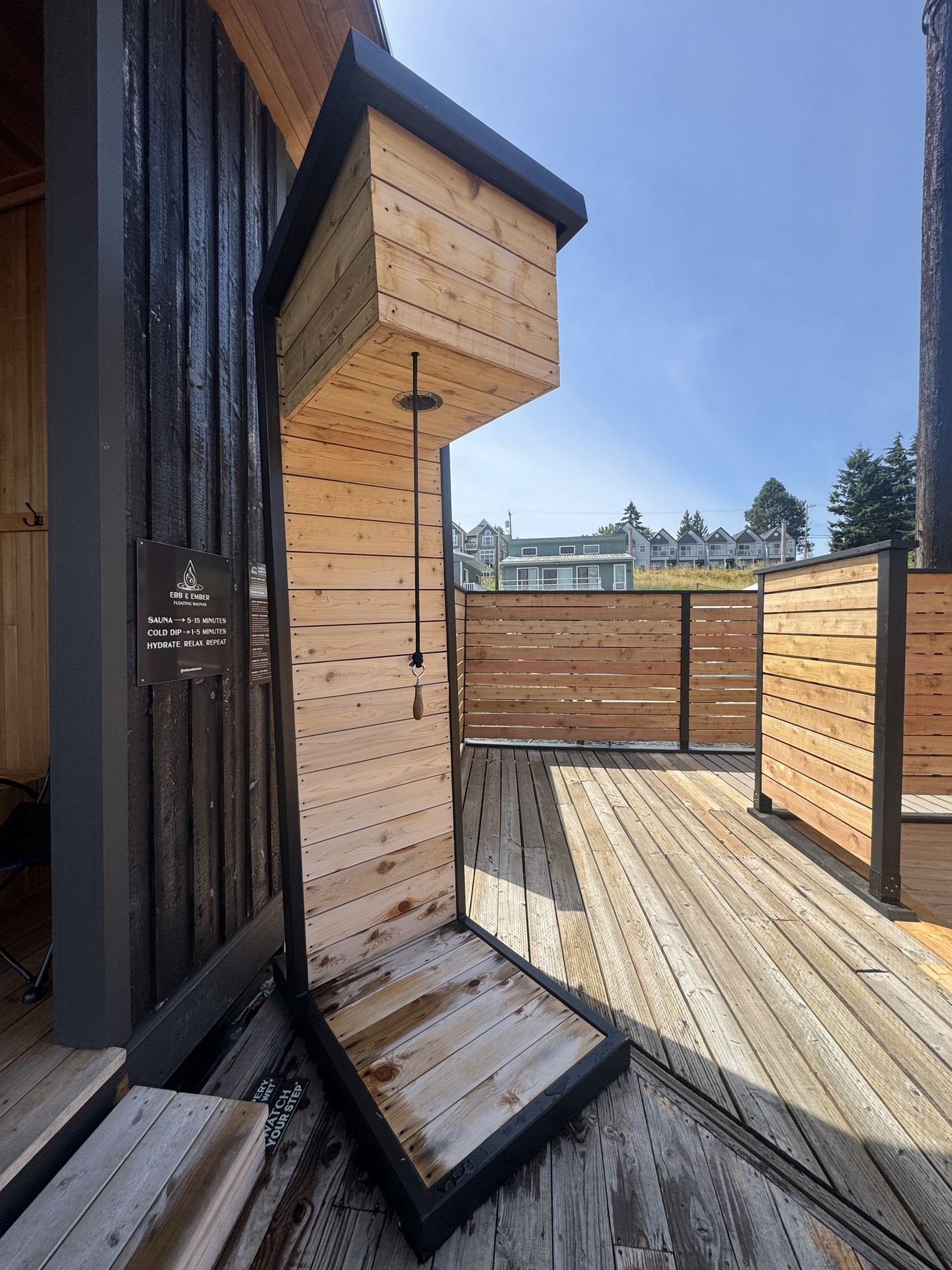Warm cedar entry of the Ebb & Ember floating sauna looking out toward the river