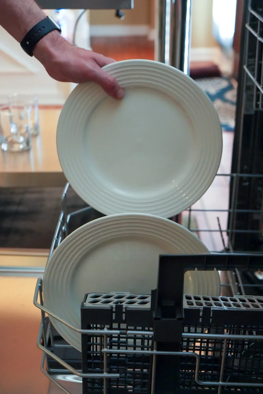 Dishes being placed in the dishwasher