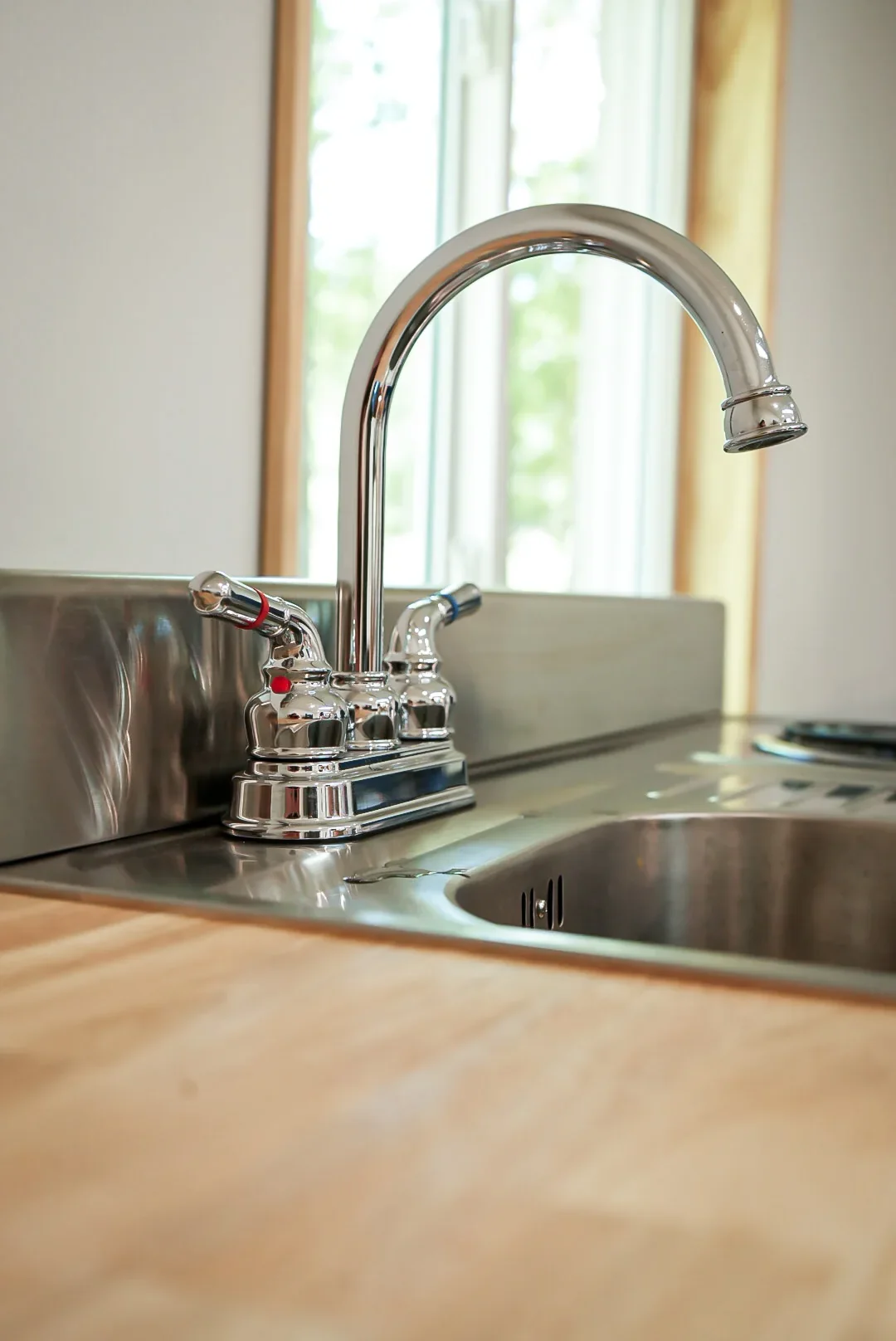 Faucet beside the butcher-block preparation counter