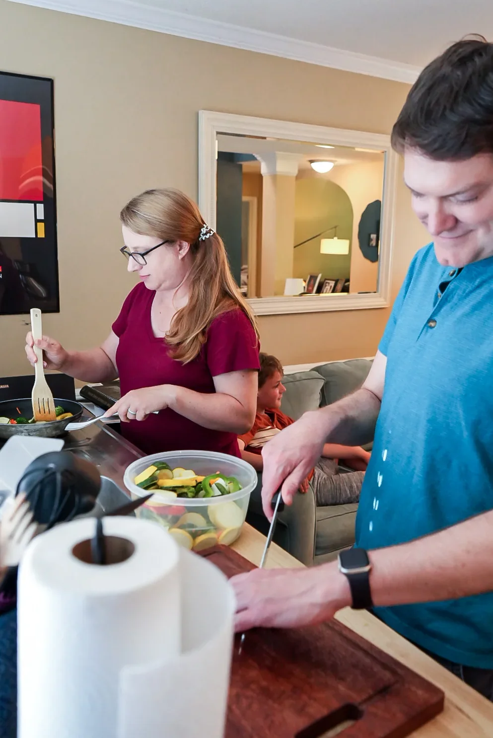 Family cooking dinner together at the stove