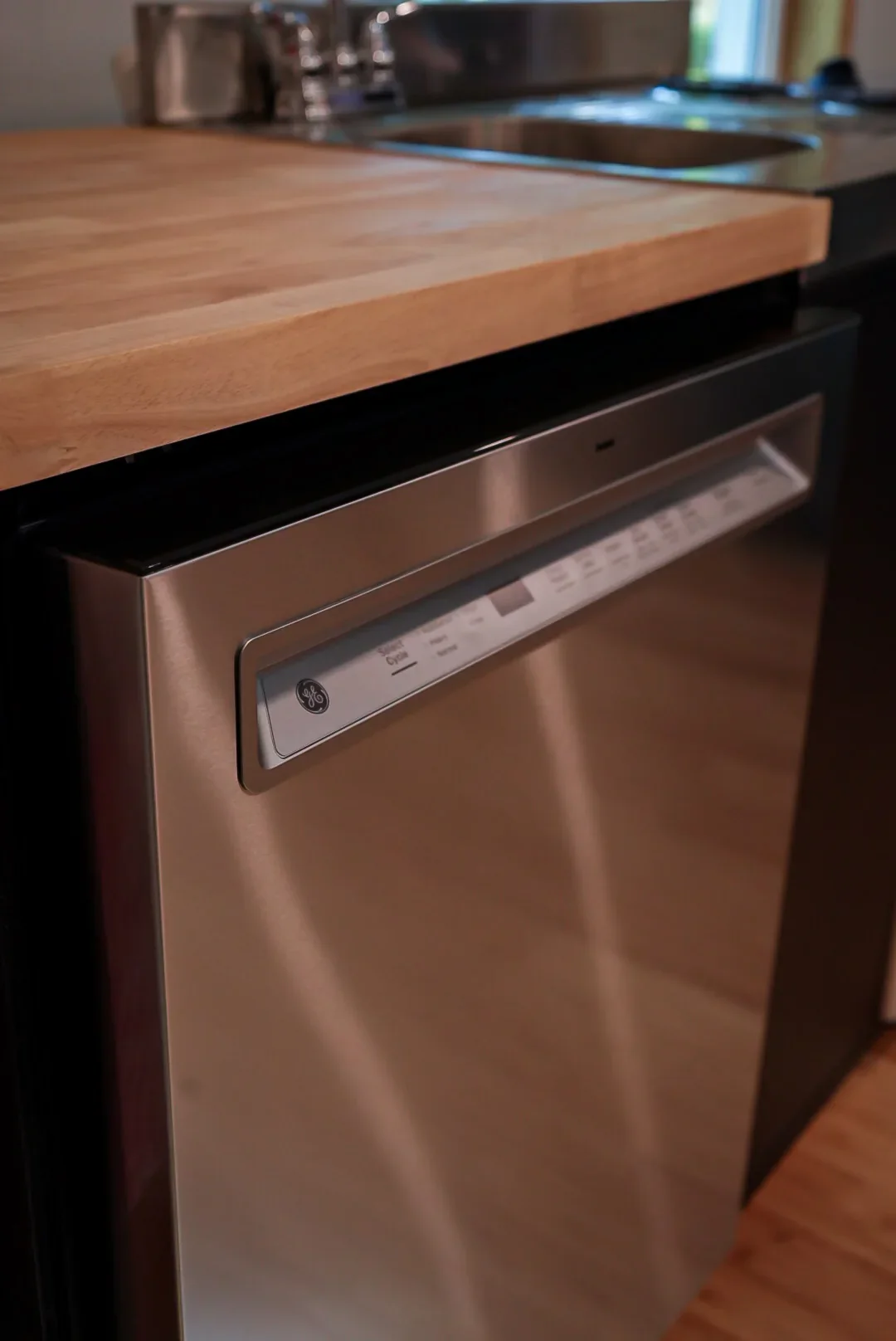 Dishwasher beneath the butcher-block counter
