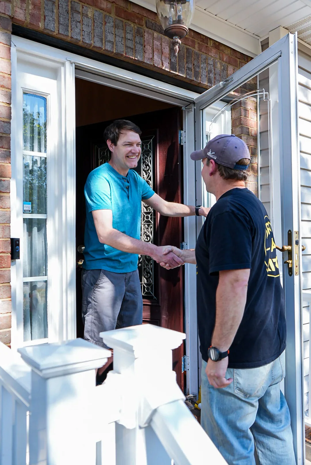Delivery team member shaking hands with a homeowner
