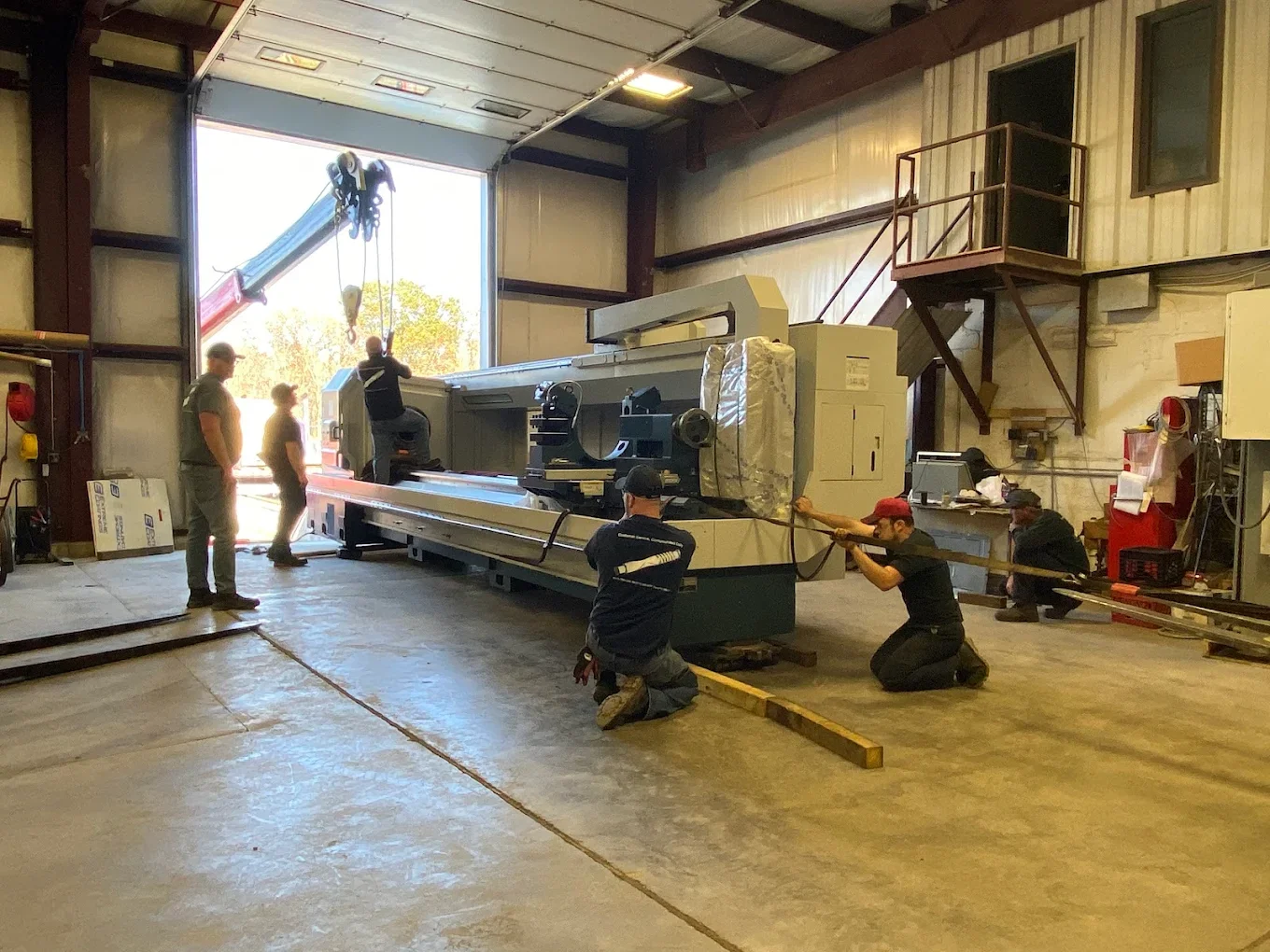 TPEI team positioning heavy equipment in the manufacturing facility