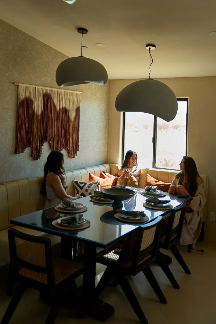 Friends sharing dinner at the banquette on a girls' weekend