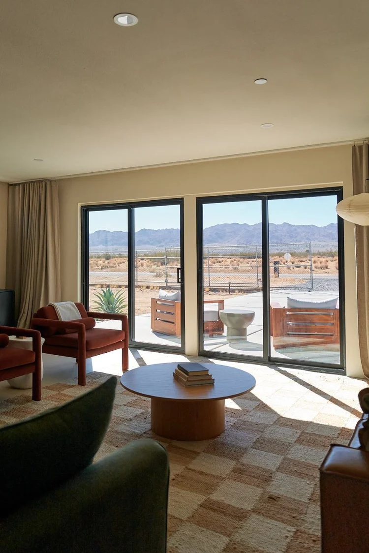 Red armchairs and a desert mountain view from the living room