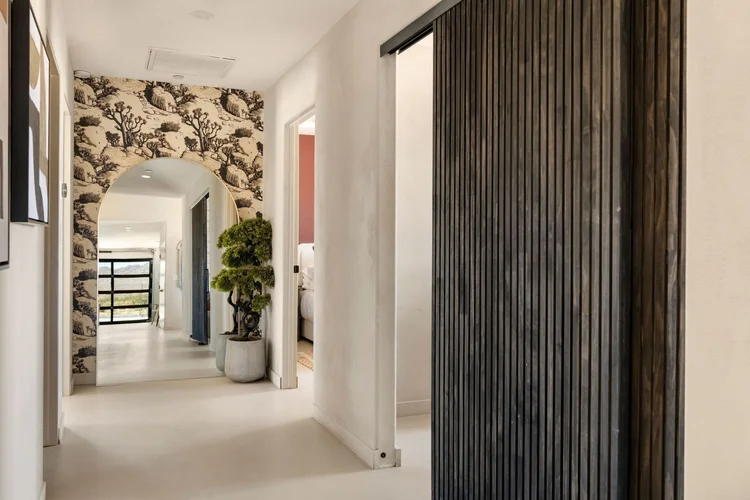 Arched hallway mirror and olive tree