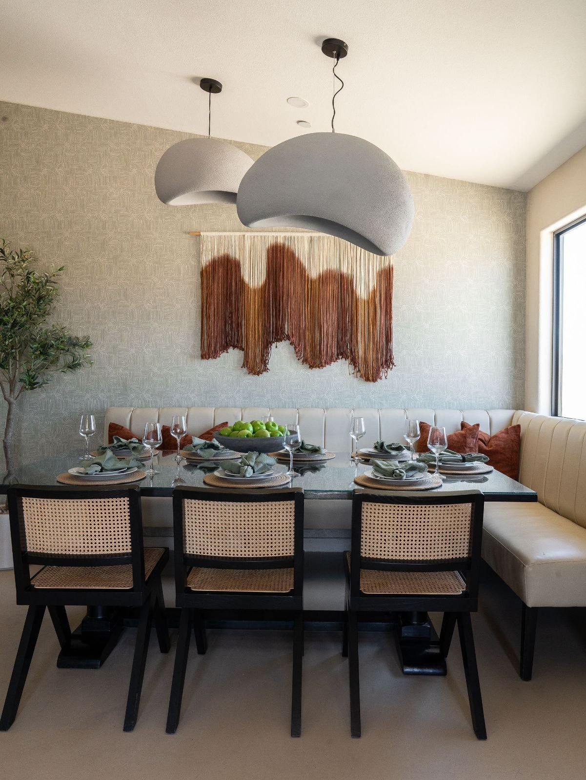 Glass dining table and white banquette at The Desert Willow Joshua Tree