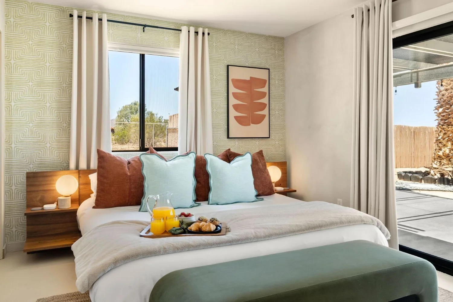 King bed with a breakfast tray in the primary suite at The Desert Willow Joshua Tree