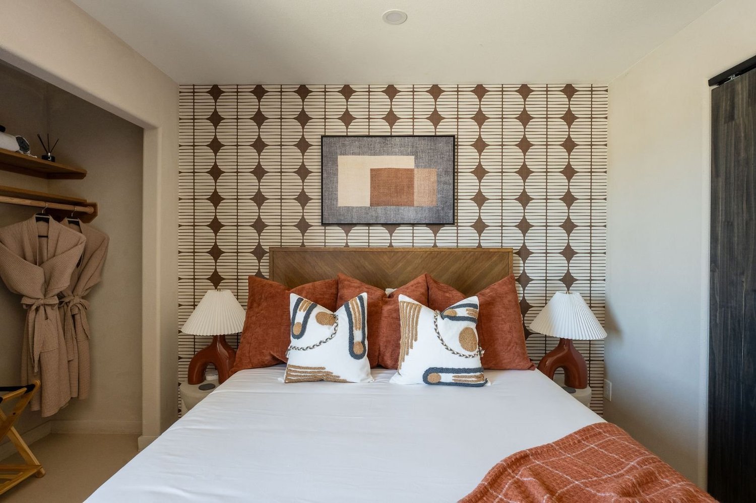 Queen bed with a geometric wall and twin lamps in the Stargazing Room at The Desert Willow Joshua Tree