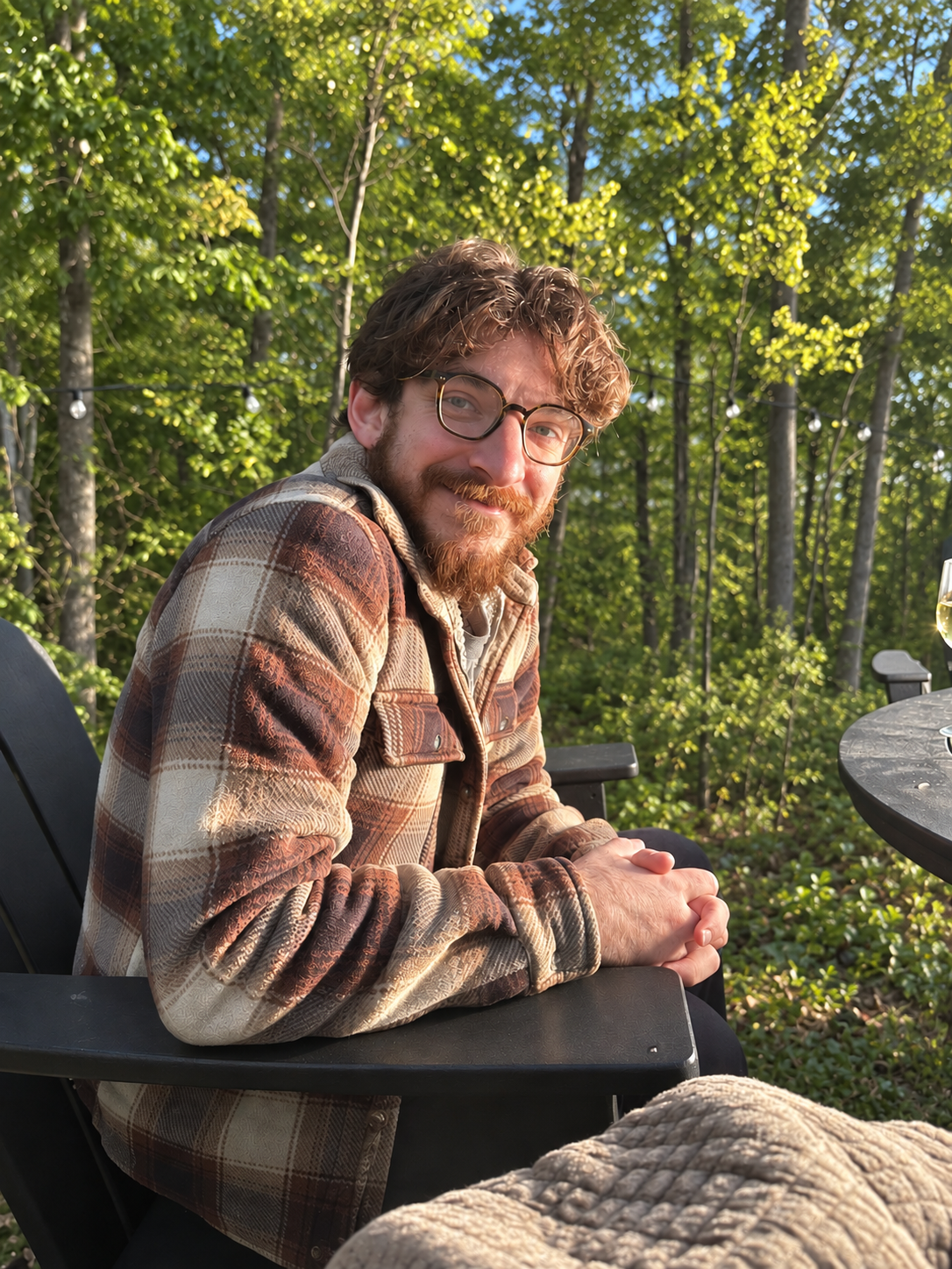 Adi Elinoff seated outdoors among trees