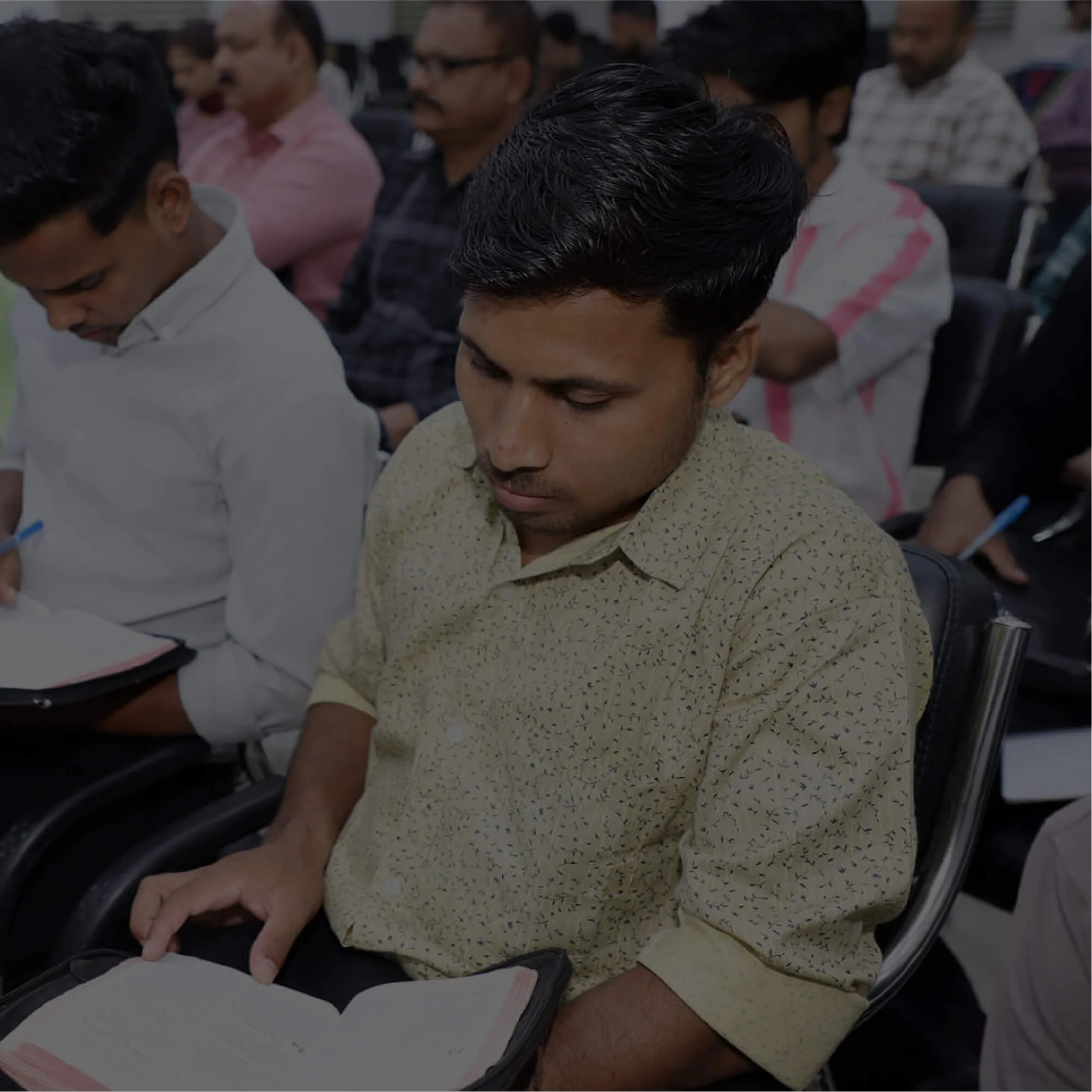 Student holding bible in class