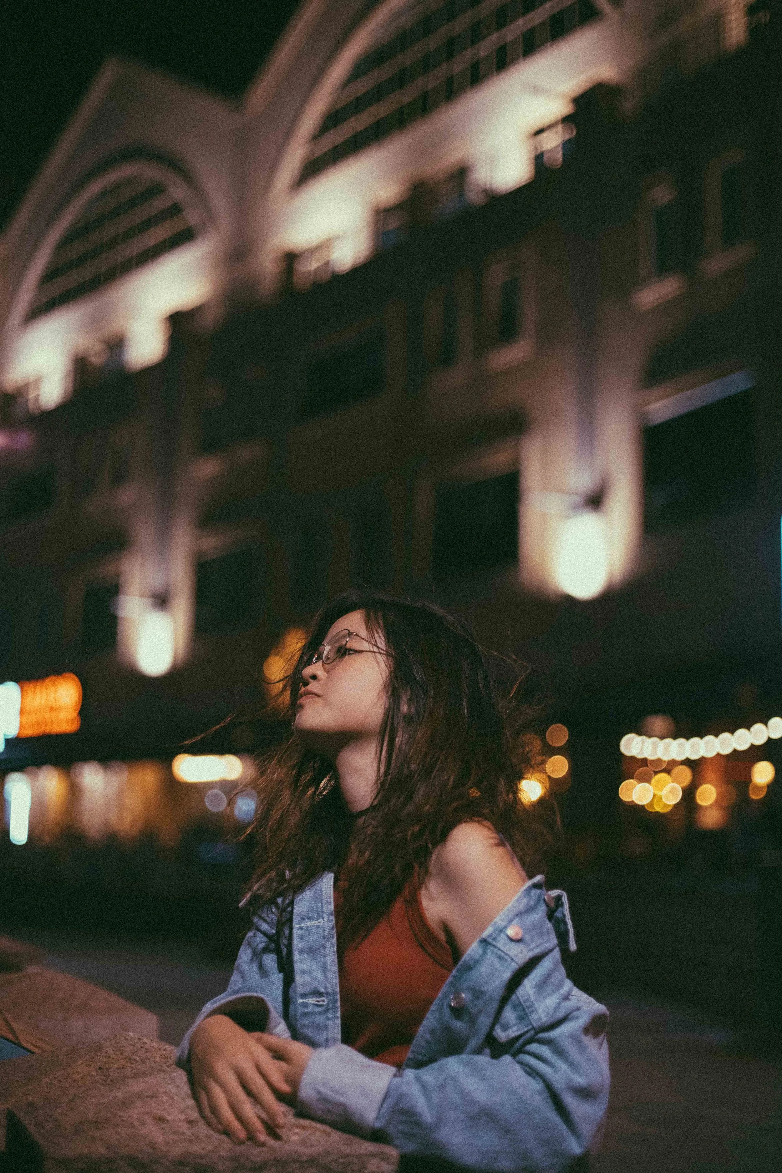 Solo night portrait of Cheryl at Clarke Quay in Singapore, lit by colourful city lights