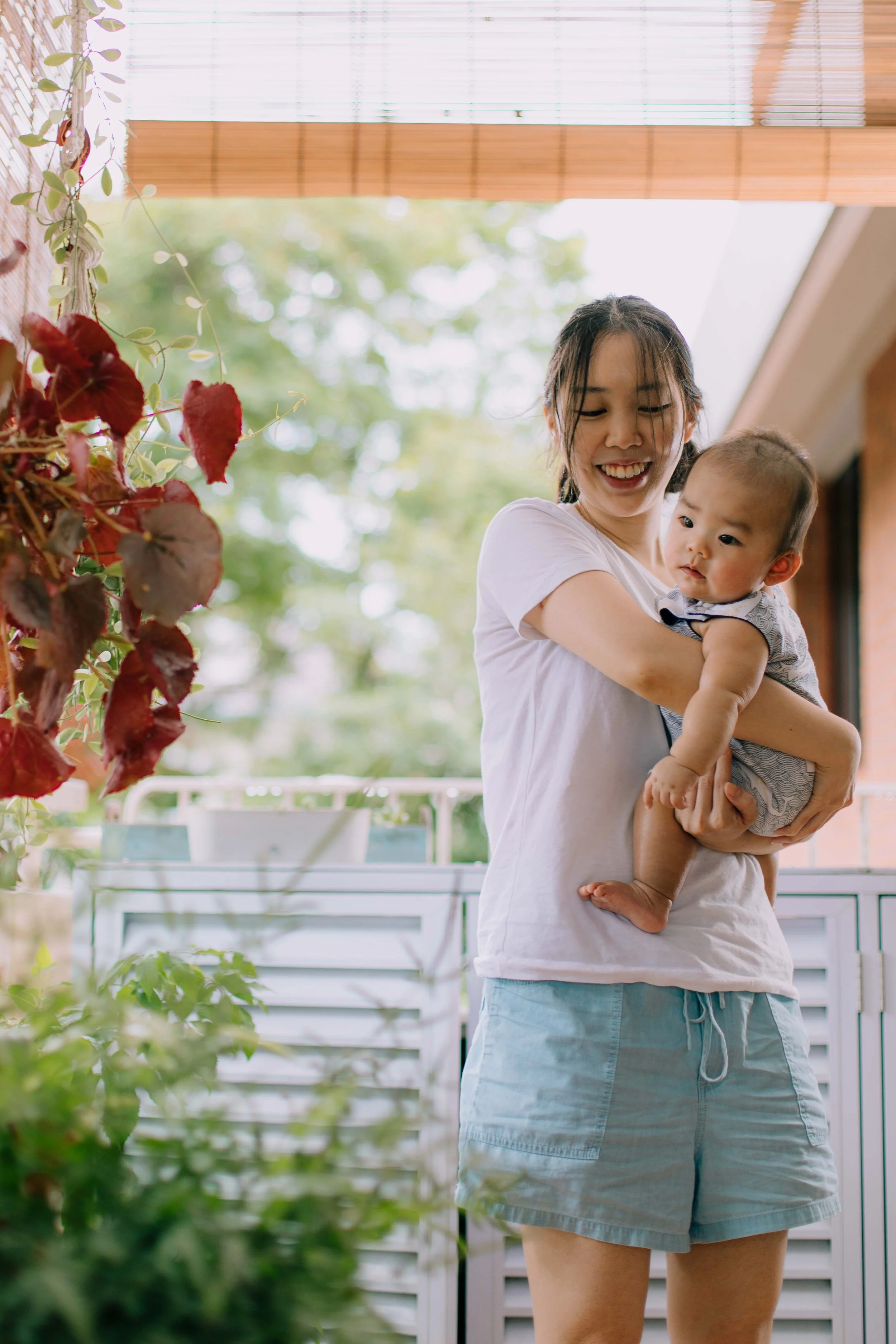 Parents with Baby M during an at-home family photoshoot in Singapore