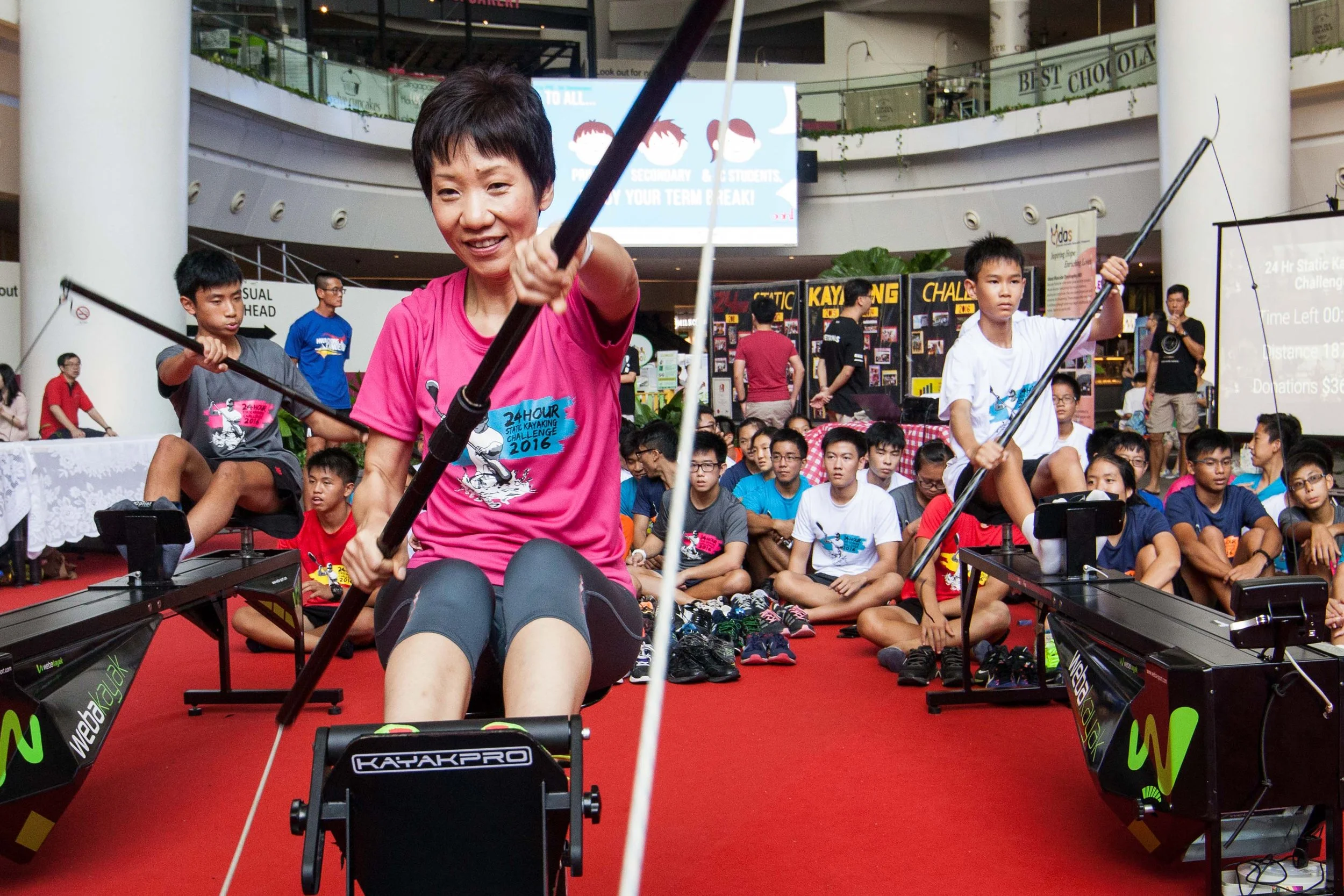Students on static kayaking machines during a 24-hour charity challenge at The Star Vista in Singapore
