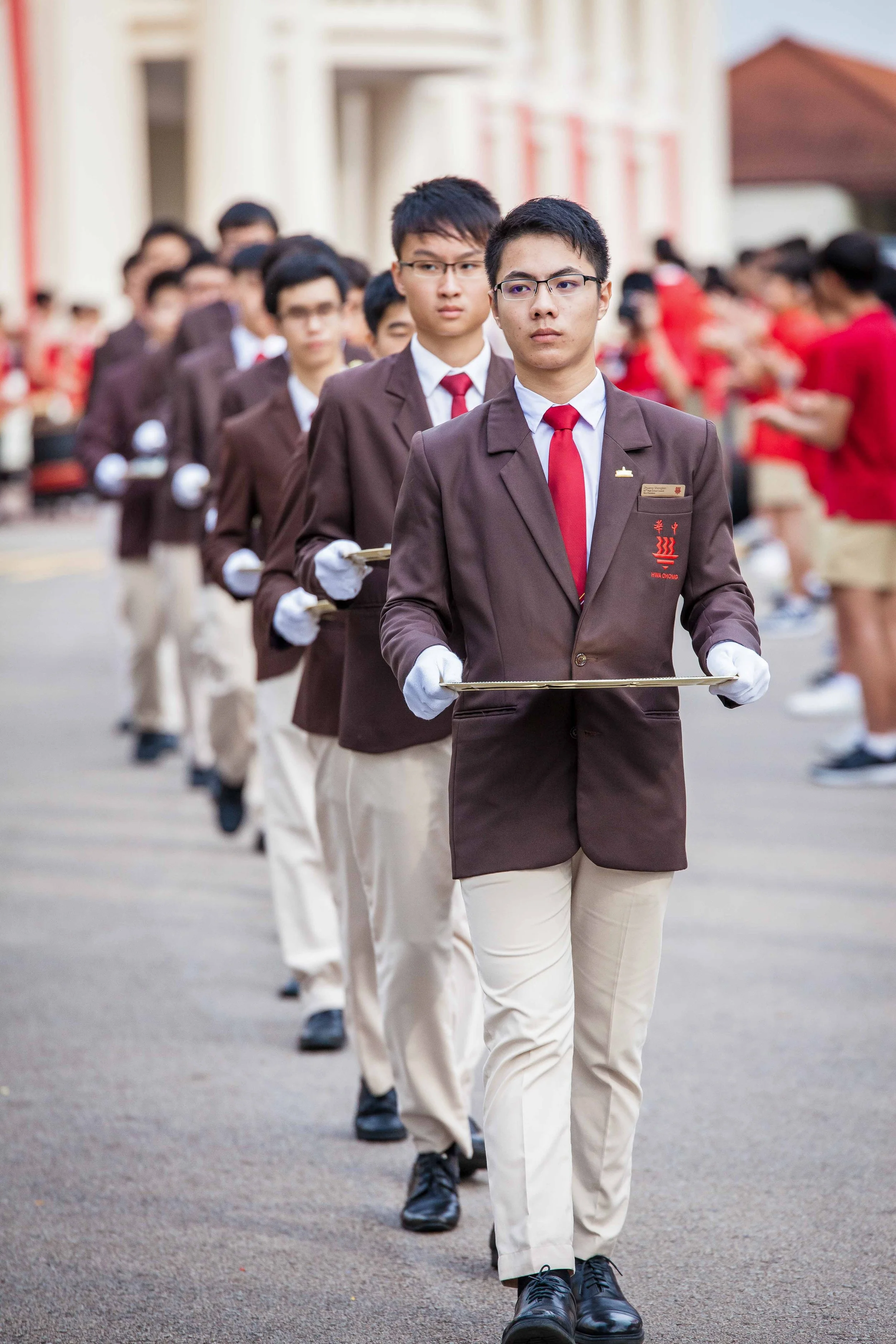 Students from Hwa Chong Institution cheering during a school event in Singapore