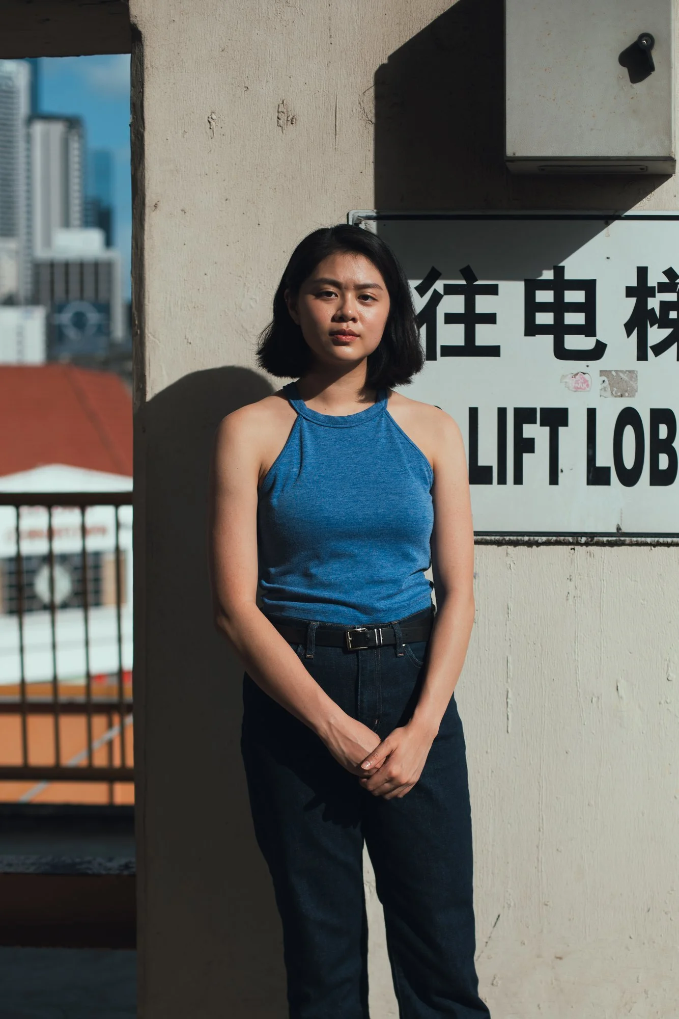 RY posing for acting headshots during a solo portrait session at People’s Park Complex rooftop in Singapore