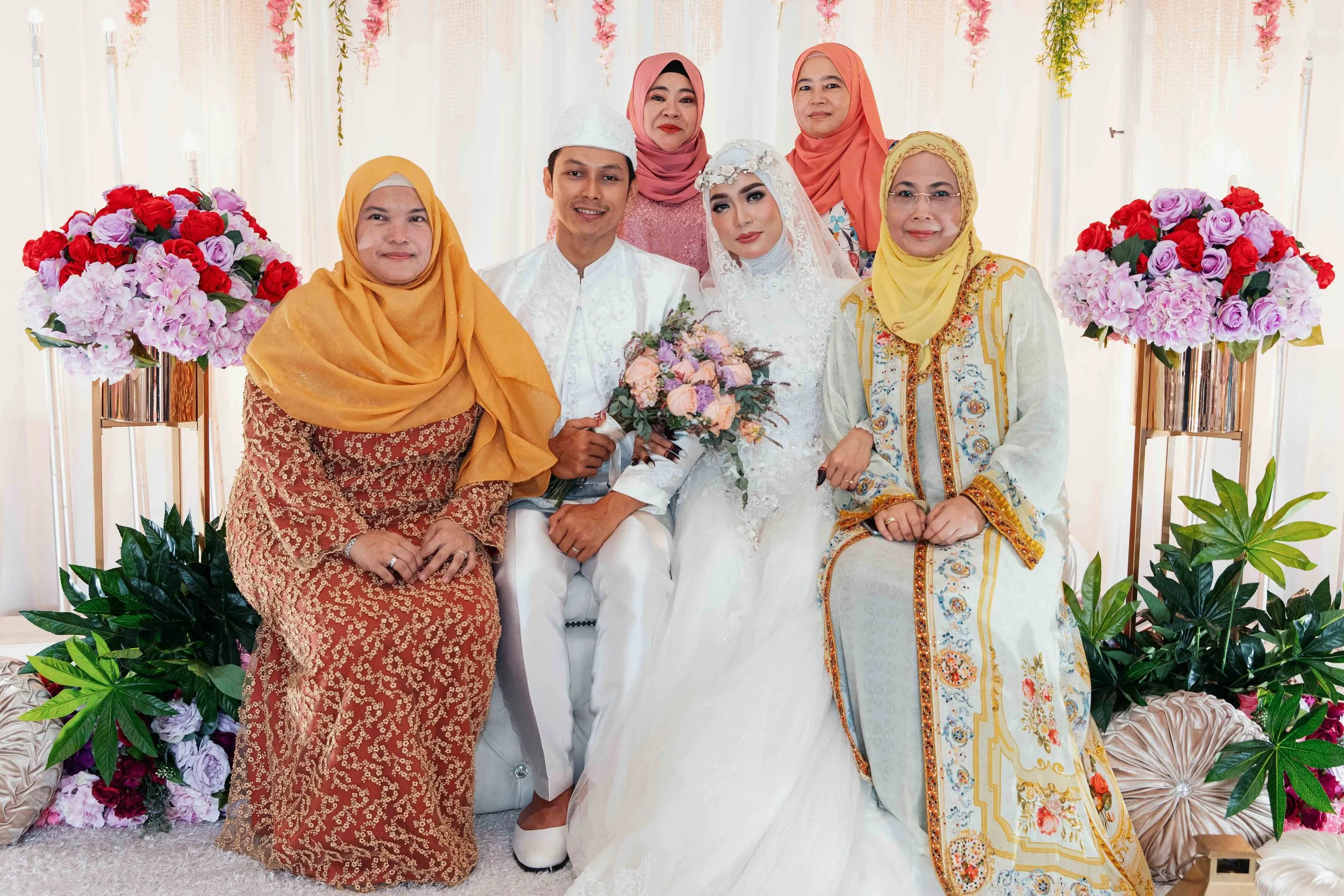 Malay couple N and M during their actual day wedding at an HDB void deck at The Verandah @ Matilda in Singapore