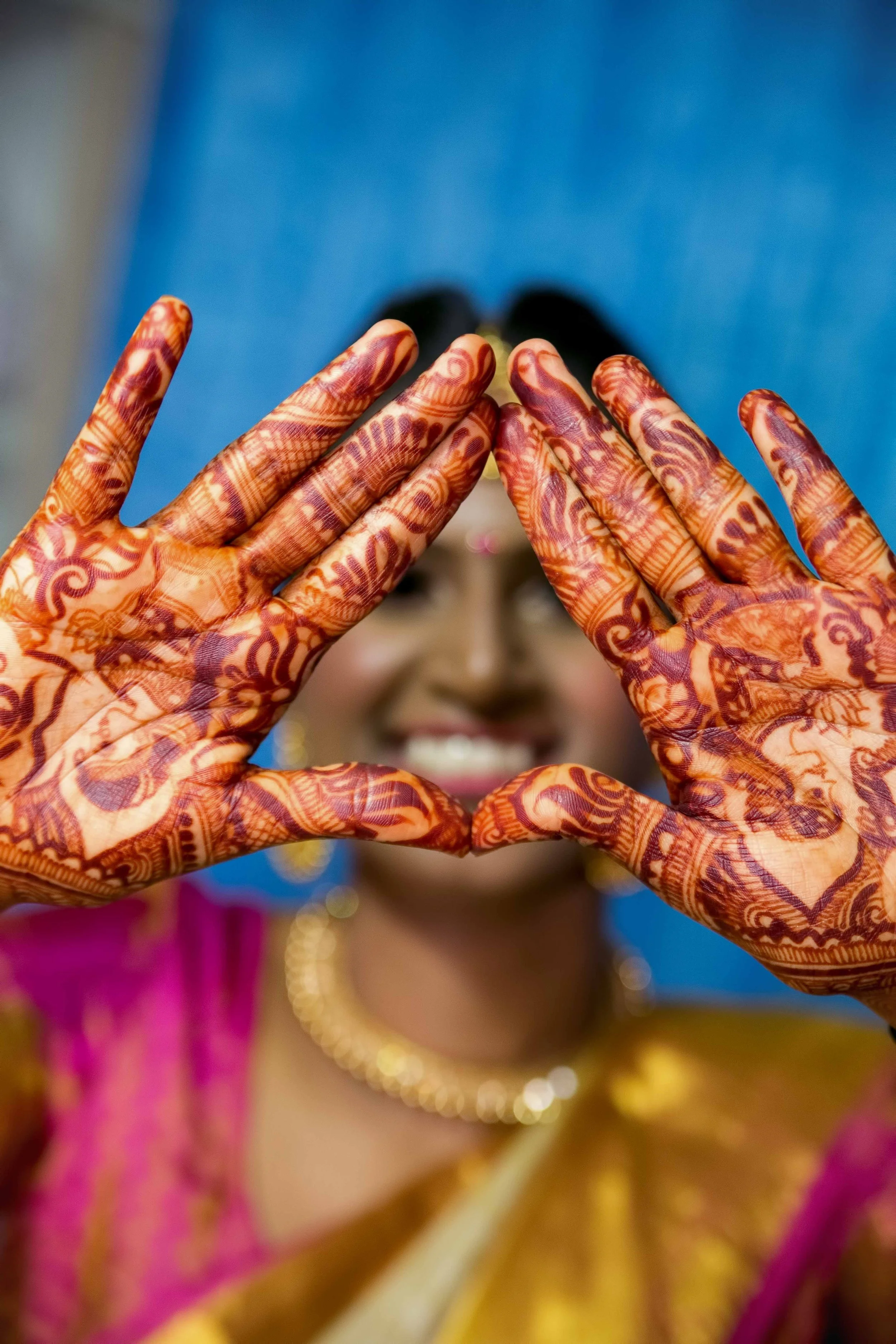 Indian bride Gaia having her Mehndi henna applied during a colourful pre-wedding ceremony in Singapore