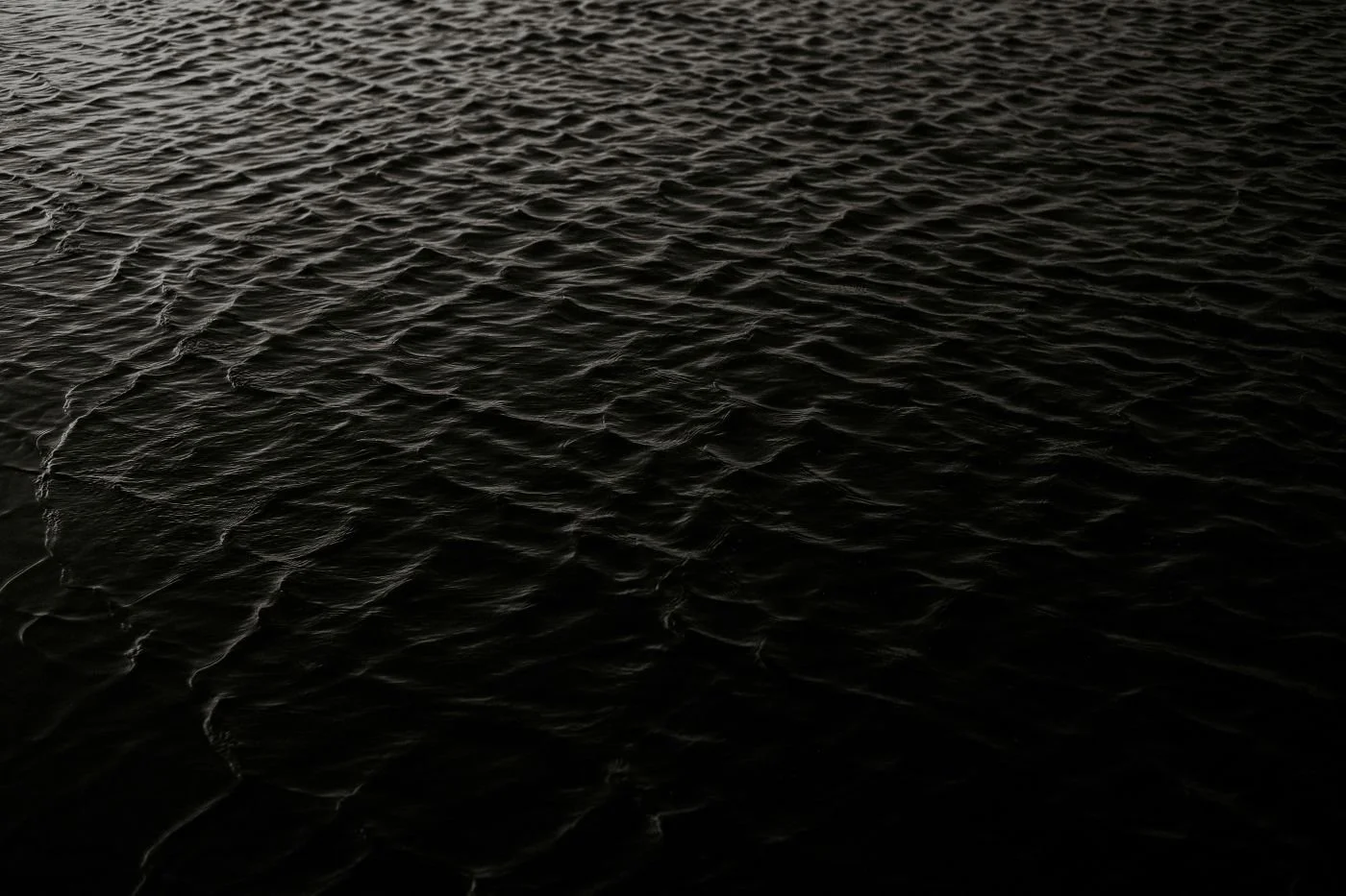 Near-black water surface texture — PVD coating depth reference