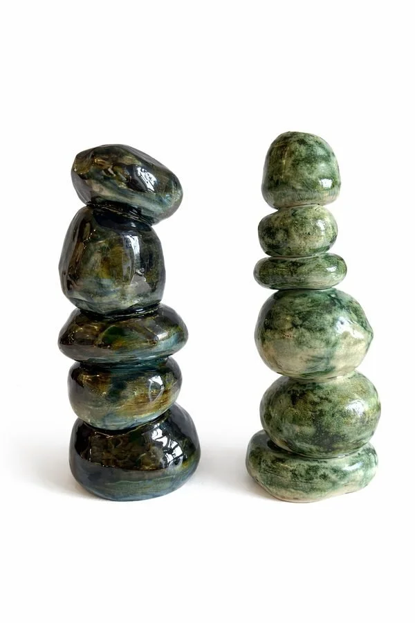 A pair of stacked stone-form ceramic sculptures in green and blue glazes