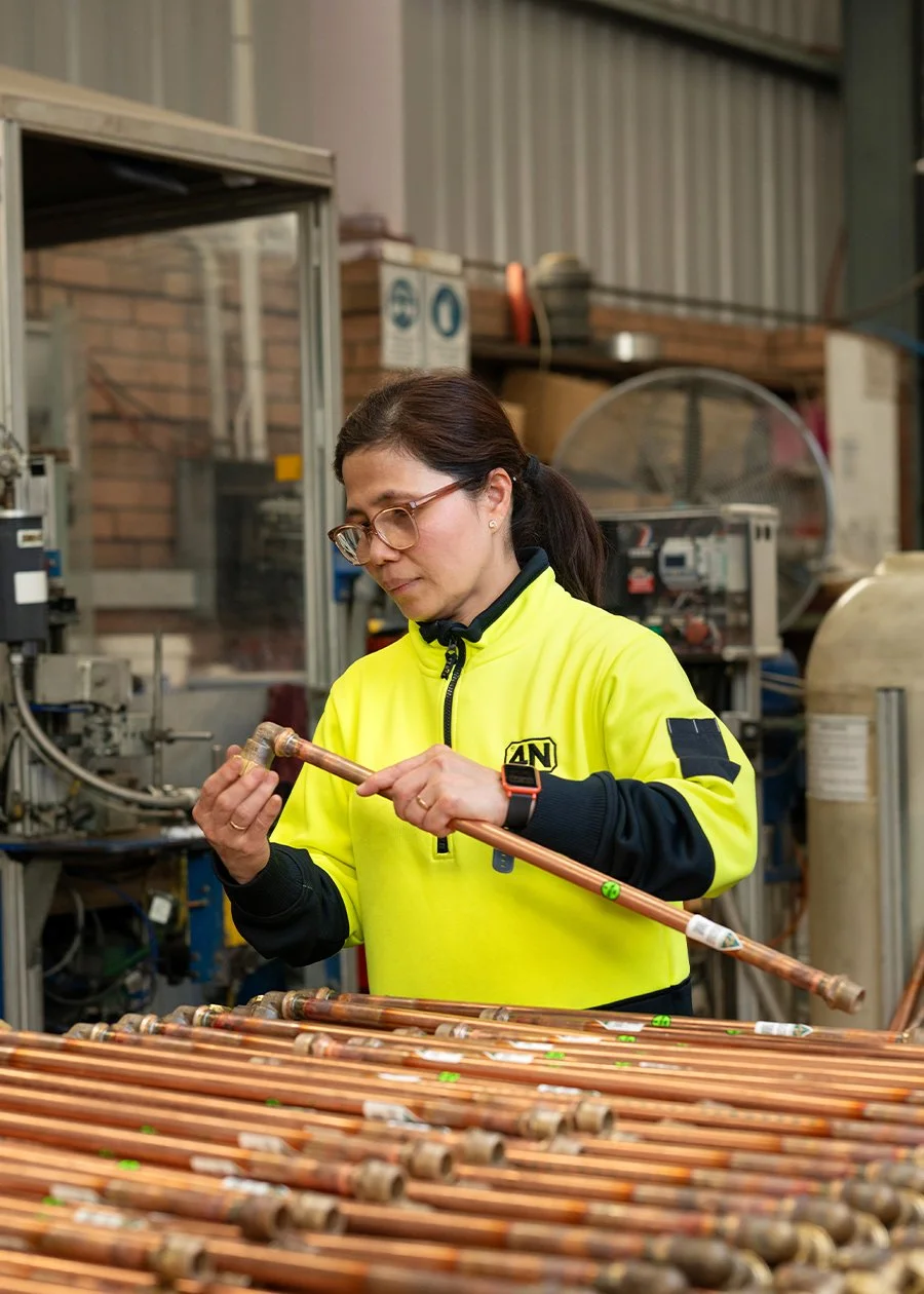 4N employee inspecting pipes