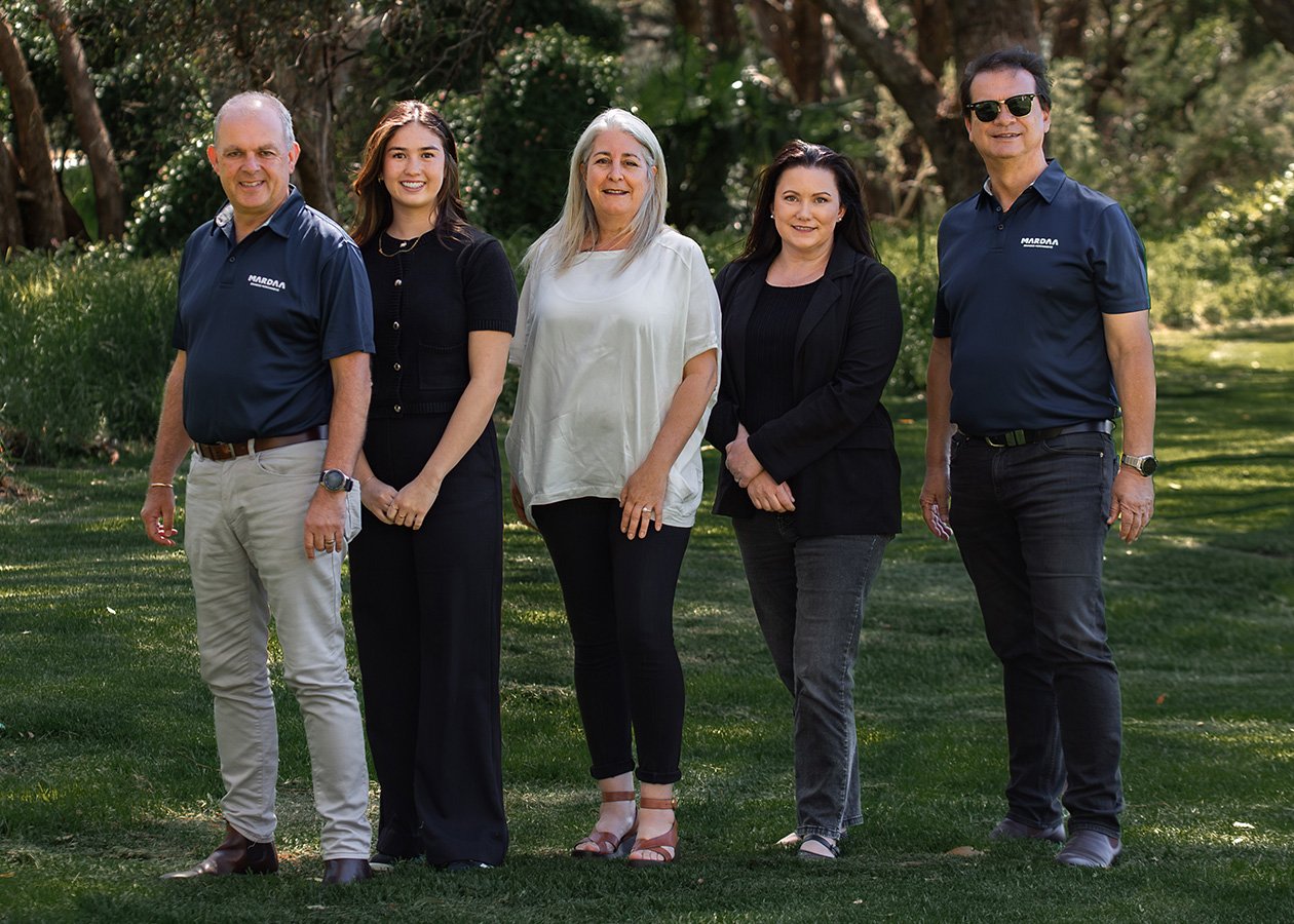 Group of Mardaa employees standing next to one another in a park