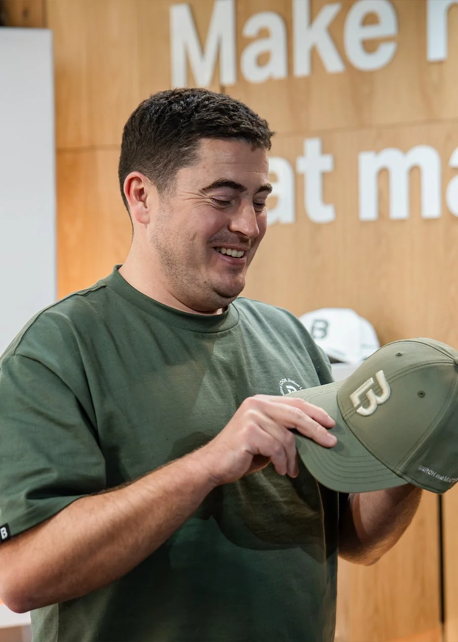 Smiling Look Brilliant admiring his new branded hat