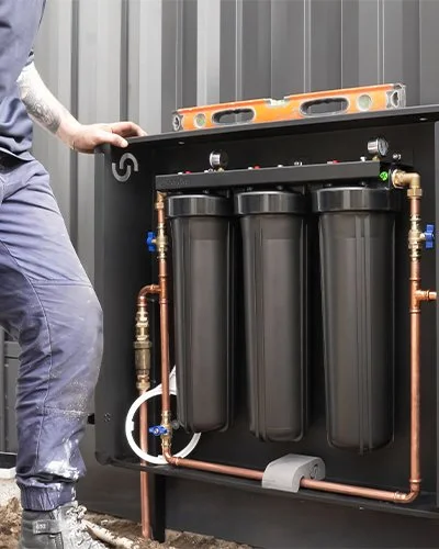 Plumber installing a Cloudtap filtration system on a property