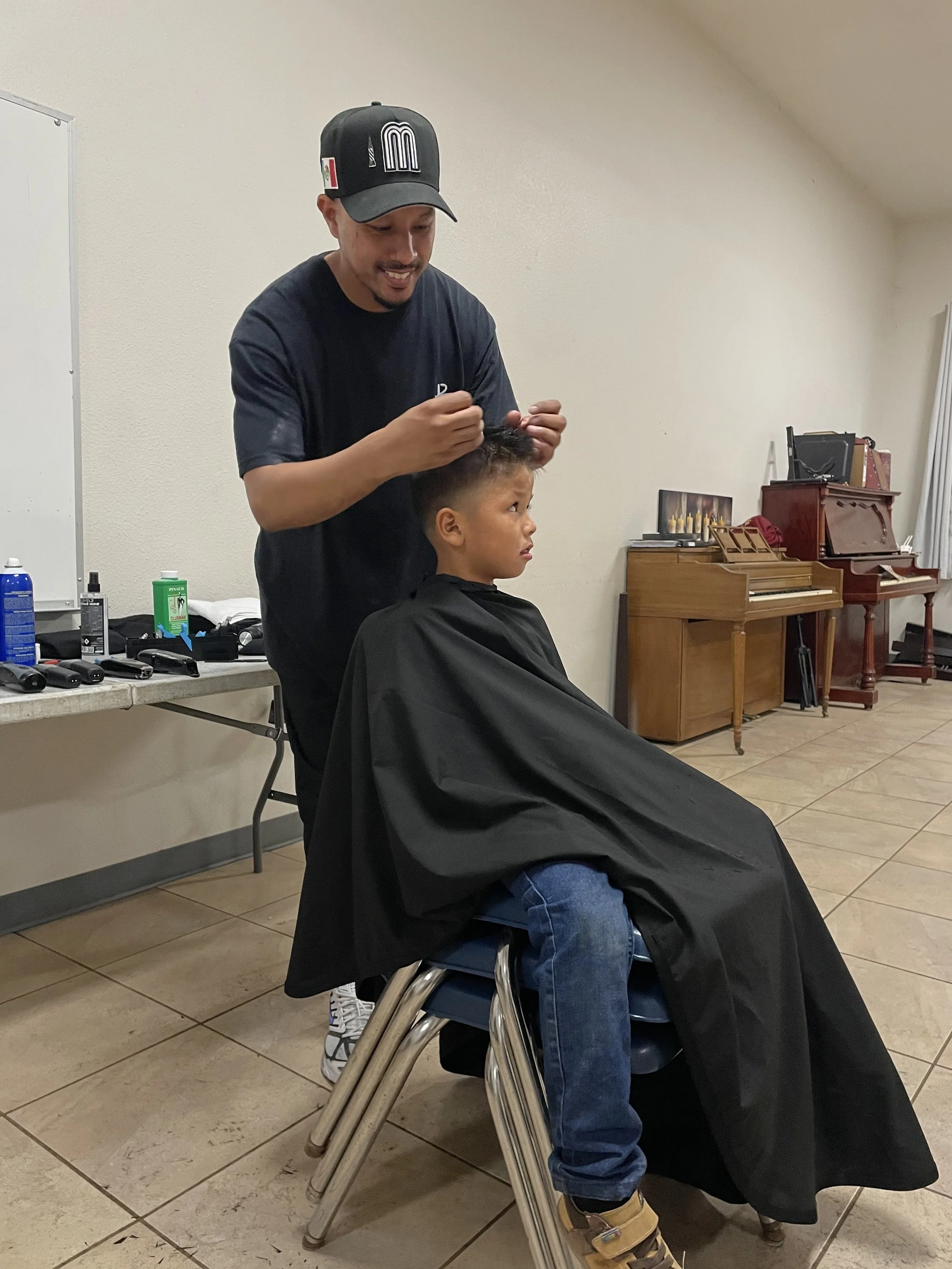 Aaron cutting hair in Ensenada