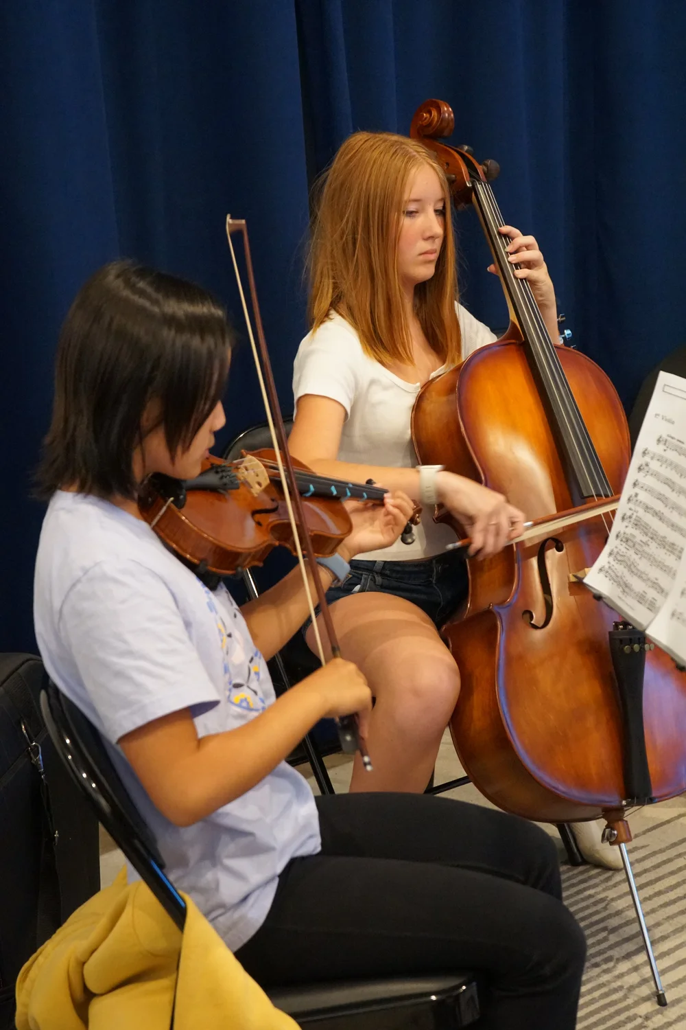 A violinist and cellist rehearsing side by side