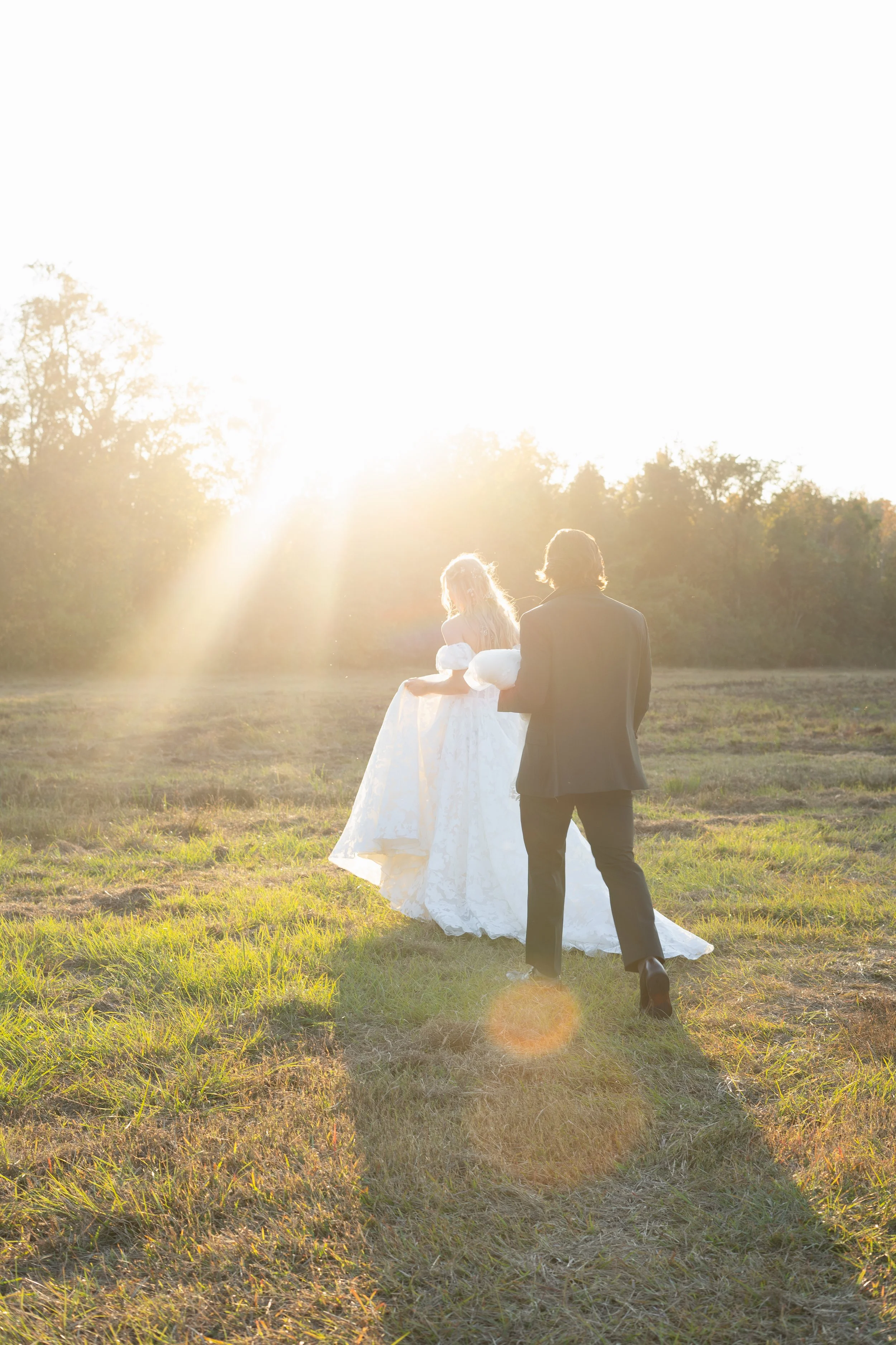 Newlyweds walking together in golden evening light