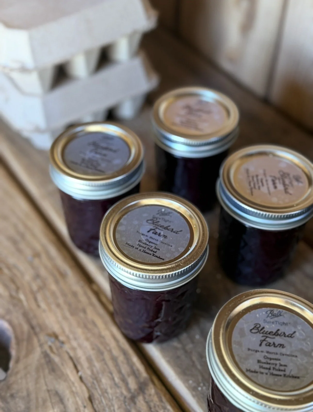 Jars of homemade jam with handwritten Bluebird Farm labels