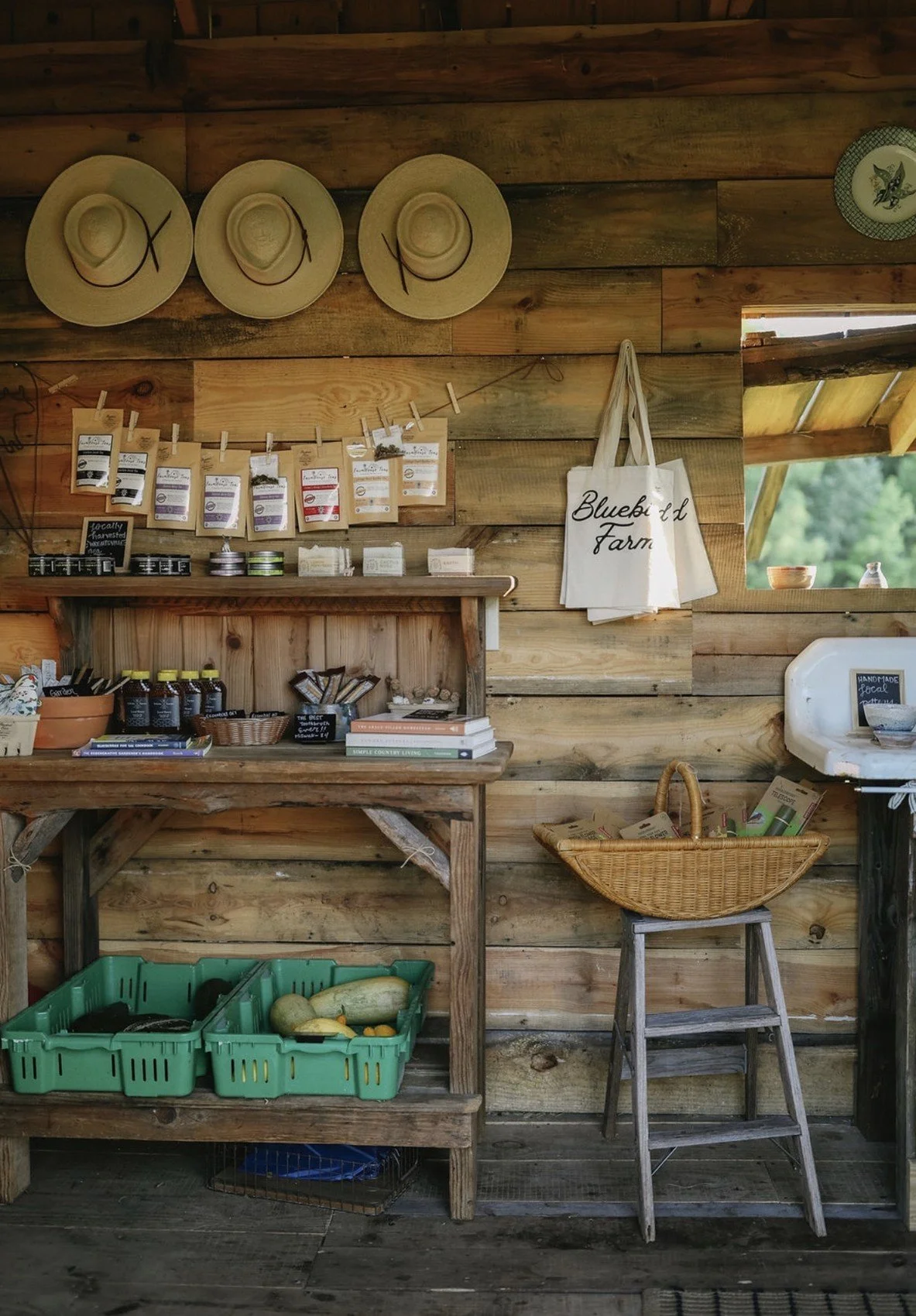 Local goods, teas, hats and Bluebird Farm merchandise on wooden store shelves