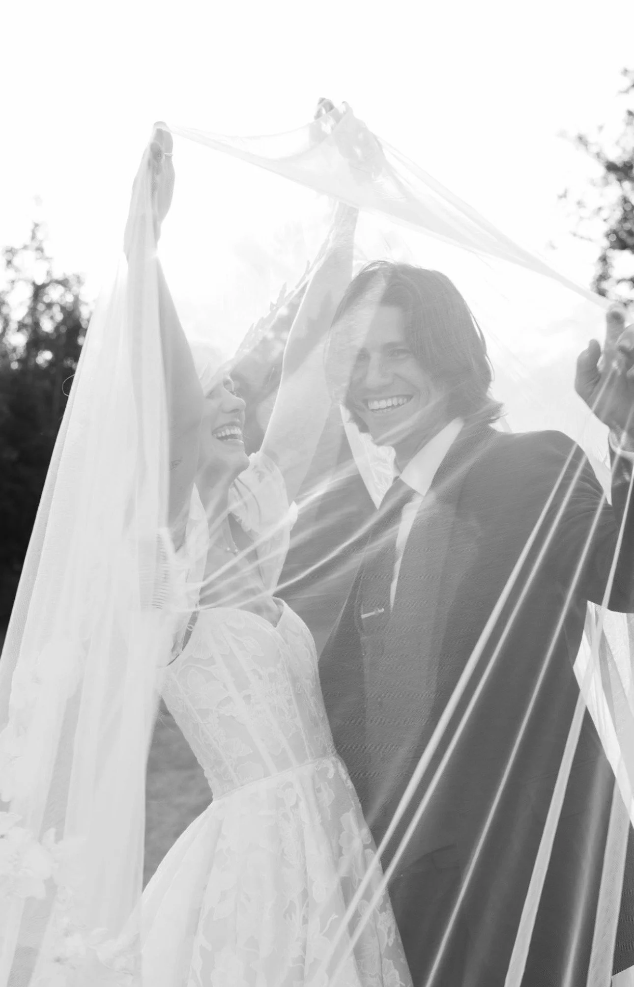 Black and white portrait of a joyful bride and groom