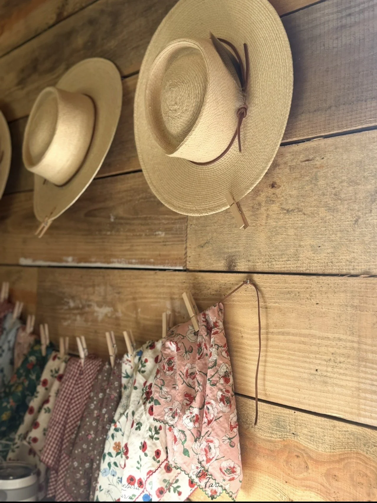 Palm-leaf hats and patterned accessories displayed on the store wall