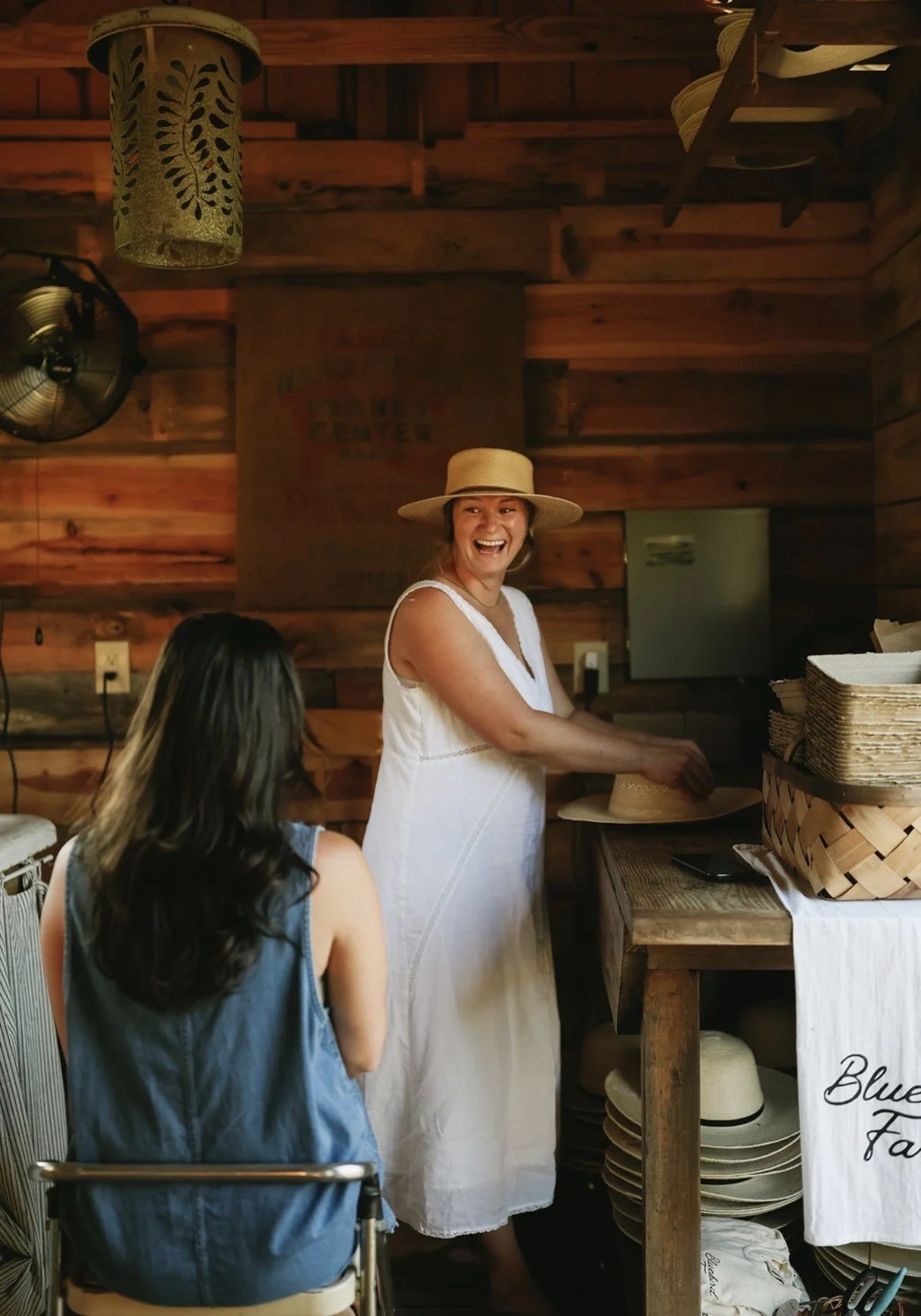 A personal hat fitting and shaping session inside the farm store