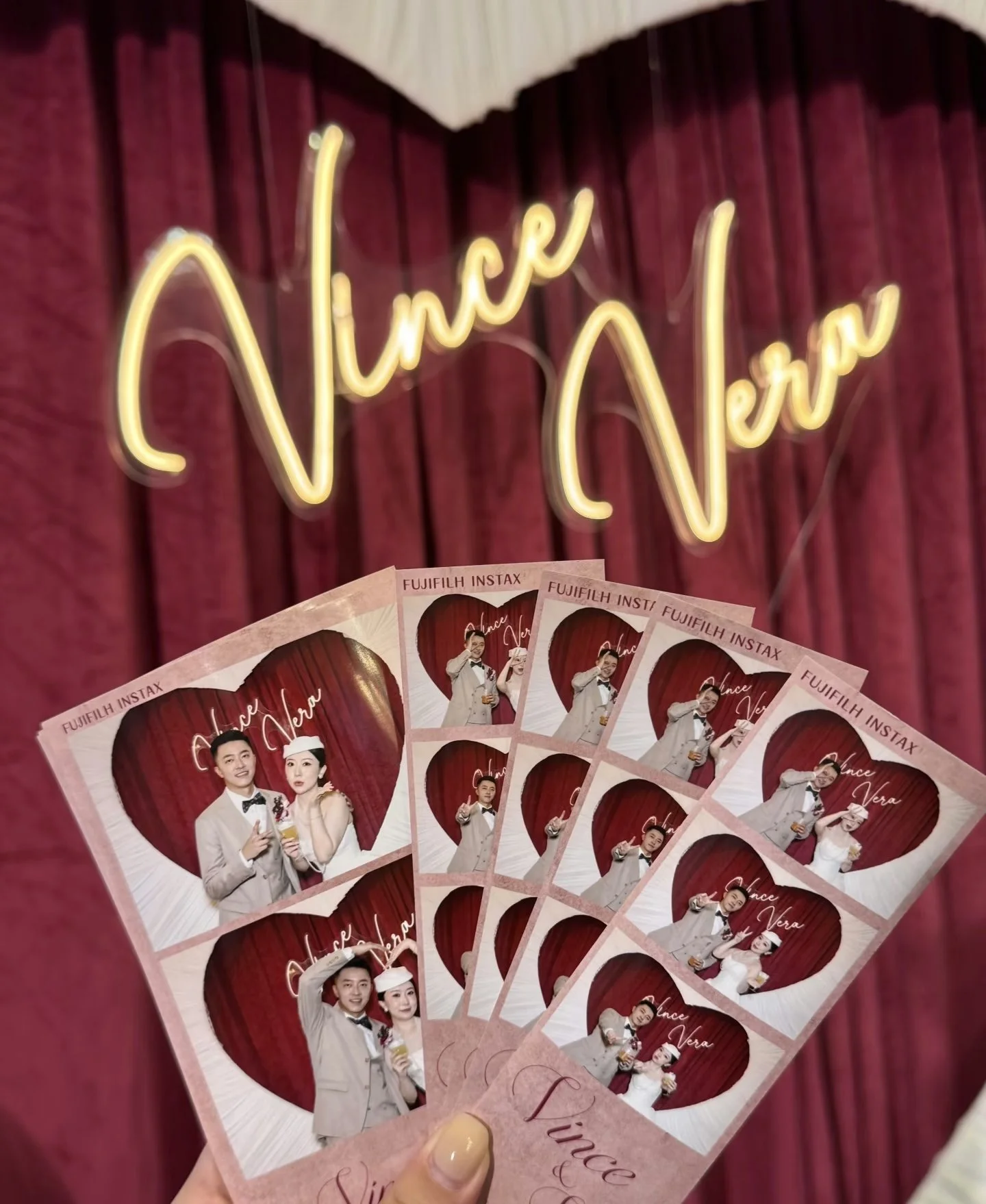 Custom wedding photostrips held up