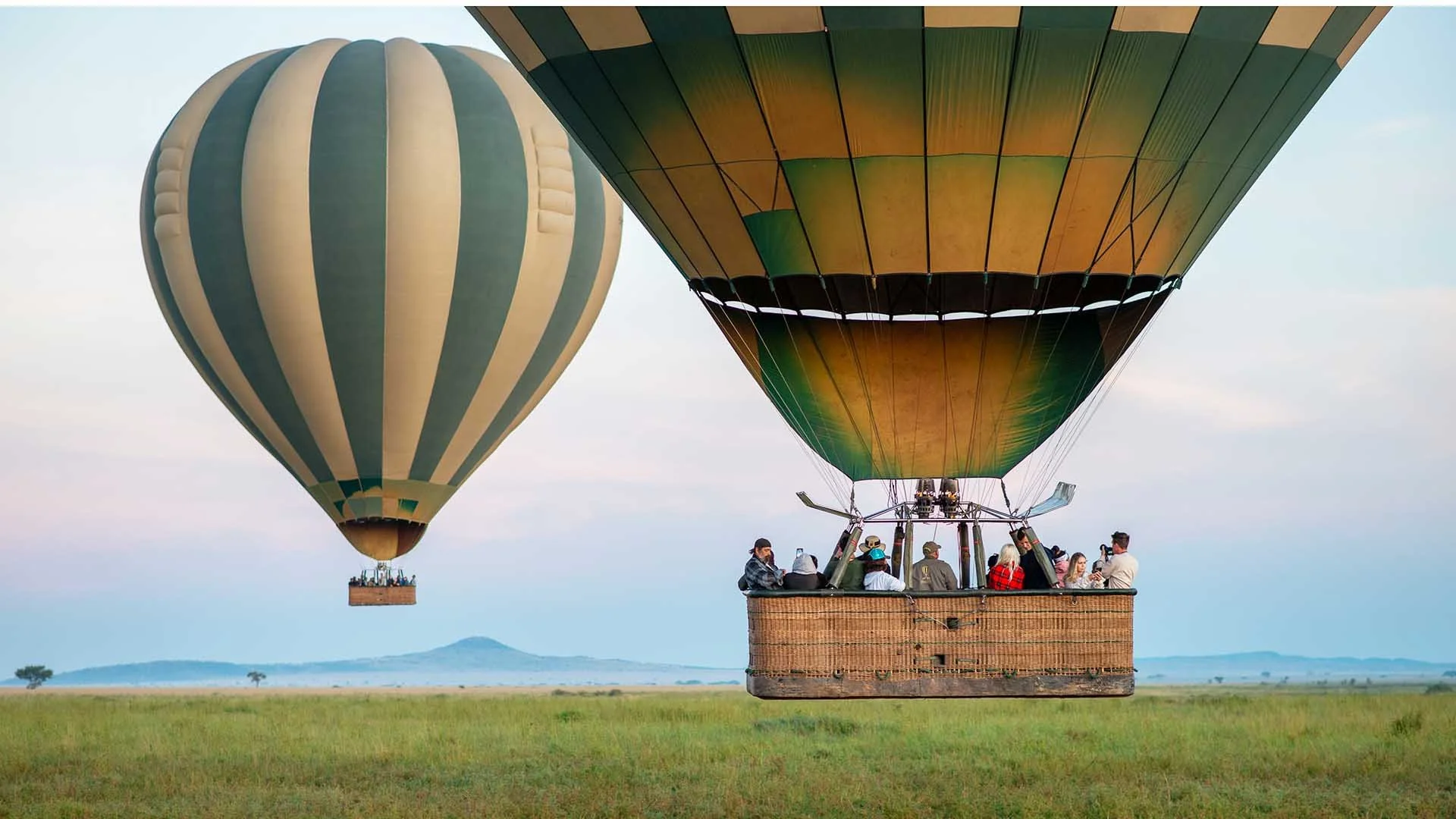 Hot air balloon launch at sunrise over the Serengeti